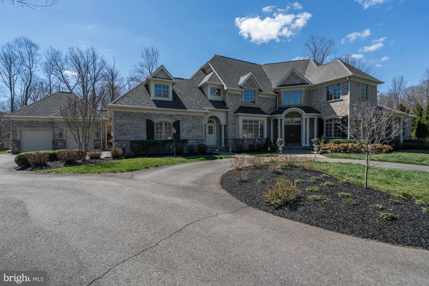 Elegantly appointed estate on very private lot with extensive hardscape incl koi pond, waterfall, deck and  stone patio. Open floor plan with multiple areas for gathering. Vast kitchen with stone fireplace, coffered ceiling, 6 burner stove, breakfast nook and large windows to enjoy the view.  Master suite w sitting rm and generous sized bathroom. Fin lower lvl with media rm, wet bar and wine room