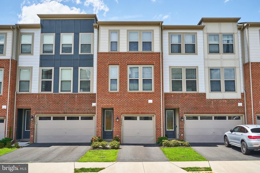 Rarely Available 3 Level 1 Car Garage Townhouse in Neighborhood of more expensive 2 Car Garage homes! Part of Stone Ridge with all of the amazing amenities and just off Route 50 near Dulles Airport Corridor, Chantilly, Ashburn, Leesburg, Aldie and Middleburg. So many options!!
Enter into the Ceramic Tile  Foyer Leading to the Lower Level Bedroom with its new LVP flooring.  Spacious 9' Closet and Door to the Rear Fenced Yard with Patio.  Up the Stairs you will find the Main Level with Hardwood Flooring, 9' Ceilings and an open and bright floorplan.  Recessed Lighting and Ceiling Fan pre-wire.  3 Windows add lots of light.  The Spacious Kitchen/Dining Area stretch across the back of the house with a door to the composite deck overlooking an open common area.  Lovely upgraded Cabinets, Granite Countertops and a Subway Tile Backsplash show off this space.  The upgraded Double Oven/5 Burner Gas Range, French Door Refrigerator with Door Dispenser, Above the Range Microwave and Dishwasher are all in Stainless Steel.  There is also a nice pantry.  Upstairs the Wood Hallway leads to two Bedroom Suites with 2 Full Ceramic Tile Bathrooms with Granite Vanity Tops.  One Room has a walk in Closet plus another closet.  This home is less than 4 years old so no worries about needing updates!  There is so much extra parking throughout the community along with a wonderful Tot Lot and Basketball Courts less than a block away!  This one is ready now!  Open Sunday 7/25 1-3pm.