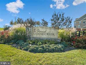 LOCATION TELLS IT ALL! Beautiful end-unit 4-level townhome style condo in desirable Preserve at Goose Creek. Corner unit with incredible views from top level balcony! Sunny and bright spaces throughout! Main level features wide-plank distressed hardwoods throughout, sunny dining room and living room with access to ground level patio. Relax by your electric fireplace. Kitchen includes gorgeous cabinets, granite countertops, and stainless-steel appliances. Single car garage with extra room for storage. Second level is the private owners suite including a spacious bedroom with ceiling fan, sitting room, large walk in closet. The owners bath includes granite countertops, double sink, oversized soaking tub, and separate stall shower. Laundry room conveniently located next to owners suite. Third level includes two bedrooms with sunny windows, and a large, shared bathroom. The fourth level is a fabulous loft space with hardwood floors, wet bar, and additional storage. The view from the private balcony is not to be missed; you can see for miles! Two heating/cooling systems and ceiling fans for energy efficiency. HOA/Condo includes water & sewage utilities, lawn maintenance, common area and recreation facilities -- outdoor pool, multiple play areas, gym, and banquet hall. Home has been upgraded and wired for Verizon Fios Gigabit! Attached rear load garage plus plenty of open parking for guests. Close to great Ashburn and Leesburg amenities, One Loudoun and Brambleton! Easy access to Metro station and commute on the Greenway and Rt 7. Please call listing agent for details. COMMUTER'S DREAM!! Vacant and ready for you! Any question, please TEXT to co-listing agent, Thanks!