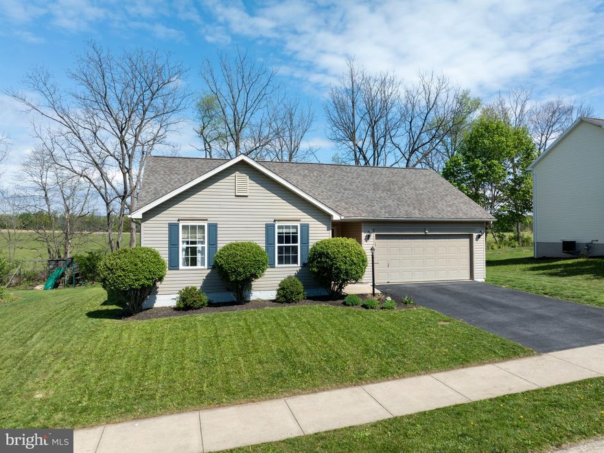 Open House Saturday May 23rd - 11:00 to 12:30.  Visit this well-maintained ranch home in the desirable Steeplechase neighborhood. Nestled against a scenic treeline, this property offers both privacy and convenience—ideally located between Bellefonte and State College, with grocery stores, breweries, and restaurants all under a 10-minute drive and quick access to I-99 for an easy commutes. Step onto the inviting covered front porch and into a spacious great room featuring vaulted ceilings and a cozy gas fireplace—perfect for relaxing evenings at home. The eat-in kitchen offers ample cabinetry, a breakfast bar, stainless steel appliances, tile flooring, and a separate pantry for added storage. The adjoining dining area provides direct access to the newly updated and stained back deck, making indoor-outdoor entertaining effortless. A main-floor laundry room doubles as a mudroom with convenient access to the garage, adding ease to everyday living. On the opposite side of the home, the generously sized primary suite features a walk-in closet and a private full bathroom. Two additional bedrooms and another full bath complete the main level. The finished lower level adds exceptional versatility, with luxury vinyl plank flooring throughout and a large recreation space ready to suit your needs—whether as a game room, home gym, or play area. A separate finished room provides the perfect private office for work-from-home days, while a full bathroom with a walk-in shower and utility sink enhances functionality. An unfinished area offers substantial storage space for organized living. Recent updates include a new roof (2021), newer kitchen appliances, updated plumbing fixtures and more modern touches. This one floor living home is truly move-in ready. Don’t miss your chance to own this beautiful property—schedule your showing today!