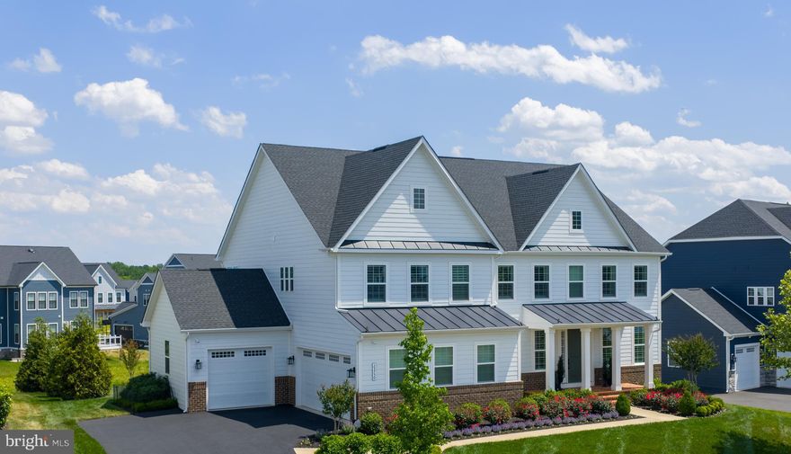 Featuring a first-floor bedroom suite, welcome to 23750 Great Bend Lane; a stunning single-family home in the highly sought-after Hartland, one of Aldie, Virginia (20105) and the greater Stone Ridge area’s most desirable luxury communities. Inside and out, this meticulously maintained home features high-end upgrades already completed, the luxury lifestyle is waiting, and everything is move-in ready to be fully enjoyed from day one.

Mornings begin with natural light pouring into the kitchen, relaxing on the stone patio surrounded by professionally established landscaping, and quiet walks through the neighborhood trails. Weekends offer a resort-style experience with afternoons at Old Farm Winery, located right within the community, time by the Hartland pool and clubhouse, fitness center, tennis matches, playground visits, or evenings entertaining with friends as indoor and outdoor living flow seamlessly together.

The sought-after first-floor bedroom suite (main-level bedroom) offers exceptional flexibility for multigenerational living, guests, or a quiet work-from-home retreat; while every additional upper-level bedroom functions as its own private suite complete with a full bath and walk-in closet. The result is a floor plan that creates comfort, flexibility, and privacy throughout the home.

Inside, this expansive NVHomes Stratford Hall model offers over 6,100 square feet designed for experience. At the center of it all is a kitchen anchored by high-end appliances including a Sub-Zero refrigerator and wine fridge, Wolf range, Wolf double ovens, an additional third oven, quartz countertops, and a farmhouse sink. The space flows into a dramatic two-story great room with generous gathering spaces, and a layout that naturally brings people together. The result is a highly functional floor plan that lives beautifully for both private routines and larger gatherings.

The upper level culminates in a magnificent primary suite designed as a true sanctuary. A private sitting area offers a quiet space to unwind, while the spa-like primary bath features dual opposing vanities to ensure completely separate, personalized space. The experience is completed by a massive walk-in closet equipped with a high-end custom closet system, offering effortless organization.
The finished walk-out lower level, over 1,850 finished square feet, including a full bath adds exceptional flexibility for entertaining, recreation, guest overflow, or additional living space. It serves as a flexible blank canvas; perfect for a home theater, private gym, or ultimate game room. The lower level is completed by an expansive unfinished space, offering incredible, easily accessible storage solutions.

This is the rare opportunity to own a custom finished luxury home ready for immediate enjoyment in one of Loudoun County’s most desirable communities. Beyond aesthetics, the home offers the practical luxury buyers appreciate most with a Tesla car charger, enhanced Wifi, wireless controlled irrigation, custom exterior lighting, remote access home controls, including the security system with exterior cameras. All with the peace of mind that comes with a home that has been lightly lived in and meticulously maintained.

This NVHomes Stratford Hall home at 23750 Great Bend Lane, surrounded by Hartland amenities, is just minutes from Brambleton Town Center, StoneSprings Hospital Center, and with convenient commuter access to Route 50. This Aldie home offers the exact balance many Northern Virginia buyers hope to find: modern luxury without the wait, projects, or compromises. Here, the details have already been elevated, the spaces already completed, and the lifestyle already established.

Everything buyers usually spend months upgrading after closing has already been beautifully completed.