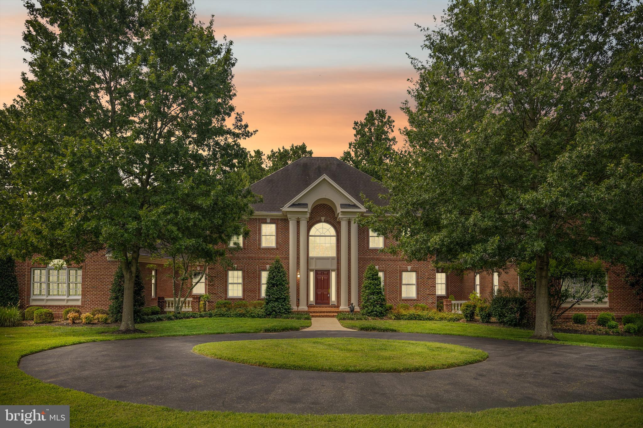 COTTAGE FARM ESTATES — Welcome to this STUNNING 6 Bedroom, 5 Full & 2 Half Bath Custom-Built Colonial on 8.11 Acres of Impeccably Landscaped Maryland Countryside -- In sought-after Cottage Farm Estates.
This custom-built masterpiece is a true showcase of craftsmanship, luxury, and timeless design, boasting over 8 acres of serene privacy and meticulous landscaping by Homestead Gardens.
Step into the grandeur of a marble-floored foyer featuring a gorgeous, curved staircase, complemented by a secondary back staircase for convenience and flow. The soaring 10'6" ceilings on the main level and 9'6" ceilings on the second floor create an open, airy elegance throughout.
The immaculate gourmet kitchen is designed for the serious chef with two distinct prep zones—a cooking side and a baking side. It features:
· 10-burner professional-grade stove - between the 2 cooktops
· 3 wall-ovens
· Granite countertops
· Butler’s pantry
· Stainless-steel appliances
The formal dining room is adorned with a custom plaster medallion ceiling and Waterford light fixtures, while triple crown molding and picture-frame detailing grace both the first and second floors, adding to the estate’s architectural beauty.
Luxury living continues with three custom wet bars, three gas fireplaces, and gleaming hardwood floors across 7,000 sq. ft. on the first two levels. Third level is carpet only.
The main-level primary suite is a private sanctuary, featuring:
· Cathedral ceilings
· Sitting room with a double-sided gas fireplace
· Wet bar
· His and hers walk-in closets
· Bose surround sound system (throughout the entire main level)
The luxurious primary bath pampers with Italian ceramic tile, a soaking tub with whirlpool jets, steam therapy shower, and a custom mahogany vanity.
The upper level offers four spacious bedrooms, each with its own full en-suite bath, while the third floor features a private den/office or potential 6th bedroom—ideal for remote work or guest accommodations.
Additional High-End Features Include:
Two laundry rooms on the main level
· Plantation shutters throughout
· All oversized UV windows for natural light and energy efficiency
· 20 KW whole-house Generac generator (200 amp)
· 1,200-gallon owned propane tank
· Professional radon mitigation system
· Three HVAC systems with four zones (all recently updated)
· Circular driveway with abundant parking
· 3-car side-entry garage
This home is professionally maintained with a relentless attention to detail. Designed for entertaining intimate and large parties. Every inch of this estate reflects quality beyond comprehension — a rare gem in one of Maryland’s most coveted countryside communities.