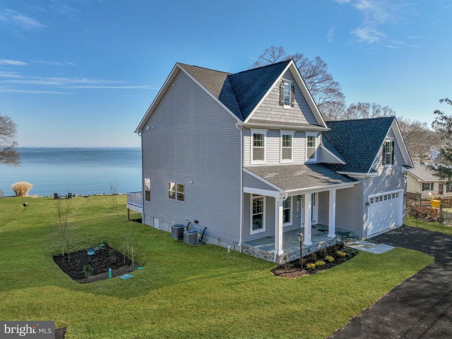 Absolutely mesmerizing views from this just-completed, 5 bedroom home at 1243 Bast Lane on Cedar Point in Shady Side. Expansive views is an understatement – look across the West River and up the Chesapeake Bay to Kent Island and the Bay Bridge. This gorgeous custom home was meticulously designed to provide views from almost every room and includes thoughtful details throughout. Best of all, there is 116 ft of waterfrontage with a private pier.  The pier has 5 ft water depth.

The open concept floor plan with 9 ft ceilings, custom molding, gas fireplace, and built-in speakers will create a delightful ambiance for family and friends alike. Experience modern luxury in the gourmet kitchen with its oversized island, stainless steel appliances, and beautiful cabinetry. The alcove off the kitchen is ideal for a cozy meal without losing the view. The adjoining family room is warm and inviting, with a custom stone mantle and propane fireplace.  Two sets of glass sliding doors, with transoms for extra light, open the space up to the back porch and allows the soothing sound of the West River into your home. There is a wonderful main level bonus room with oversized windows that could function as an office, playroom, or even a main level bedroom. The main level also has a full bath, separate laundry room, and access to the two-car garage.

Upstairs, enjoy dramatic views from the primary suite with its wall of glass. Step onto the waterside balcony and enjoy the panoramic views across the West River with your morning coffee. The gorgeous bathroom has custom tile, heated floors, a dual sink vanity, and oversized shower. Three additional bedrooms are on this floor; one with ensuite bathroom and heated floor. Two more bedrooms share a spacious bathroom, and one of the bedrooms offers huge water views.  The other bedroom has some water views and a bonus playroom. All bedrooms have phenomenal closet space, and there are three additional oversized closets on this floor for storage as well.  There are 9 ft ceilings on each level. The third level is a spectacular oasis, called the “lighthouse room”; here, you have the most expansive views, another private balcony, and a full bath. This could be an entertainer’s dream space, or an ultra-private bedroom suite. The two-car garage boasts high ceilings and ample space to store vehicles and equipment for the yard and boating. The home was framed with 2 x 6 exterior walls and includes a whole house sprinkler system, water treatment system, ceiling fans in all the key rooms, and a lovely dining table chandelier.  NO flood insurance required!  All of the builder's warranties will transfer to the new owners, and the new owners will be able to activate the alarm and sound system after settlement. 1243 Bast Lane is a departure from the hustle and bustle of daily life while being perfectly positioned for commuting or a weekend getaway.