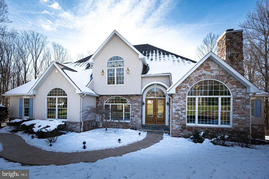 Welcome to 1114 Wilderness Trail in Downingtown’s prestigious community of Wilderness. This home is elegance personified.   Situated on a scenic 1.5 acres, this luxurious property boasts  grand spaces with expansive windows, dramatic arches and angles, rich custom detail, and inspiring natural light.  Just a few of the many highlights include three fireplaces, main floor professional office, main floor primary owner’s suite bedroom, gorgeous breakfast room, a remarkable lower level entertaining space, a 3-car garage, a long list of valuable upgrades and elevated amenities, and a stunning outdoor space with saltwater pool, Koi pond, and nature all around you.  Double-door entry leads to a grand, two-story foyer with lovely hardwood floors.  Oversized archways lead to the quintessential home office with vaulted ceiling and cozy gas fireplace, and the classic formal dining room with lovely hardwood floors, crown and wainscot detail.  Flow into the bright & cheery kitchen and breakfast room combination beaming with natural light and the ideal space for meals and enjoying time with family.  This kitchen features abundant cabinets with undermount lighting, neutral granite countertops, center island, stainless steel appliances, pantry area, and the adjoining breakfast room with a 180-degree view of nature outside.  Step outside to the deck to grill, dine, and relax, perched above a gorgeous setting with fenced yard, salt-water pool, Koi pond, and soothing tree-lined view.  Back inside and off the kitchen is the impressive great room with vaulted ceiling and floor-to-ceiling stone fireplace with custom built-in bookshelves and cabinets surround.  From here, extend your living, dining, and entertaining outside through French doors.  The main floor primary suite offers private access to the outdoor space, vaulted ceiling, 2 walk-in closets, and lovely primary bath with double vanity and corner whirlpool.  Upstairs, you will find the remaining 3 bedrooms (2 with vaulted ceilings, all with walk-in closets and ceiling fans), a full hall bath with double vanity, spacious second-floor laundry room, and linen closet.  Also here, extra storage adjoining one of the bedrooms and a large unfinished storage room above the 2nd floor.  The lower level of this home is a fabulous entertaining space!  Adding a significant amount of square footage, this level is complete with recessed lighting, stone hearth gas fireplace, wet bar, and a wall of windows offering the same gorgeous view outside and access to your outdoor oasis.  A separate suite offers the ideal space for a 5th bedroom or in-law suite with a full bathroom.  Also here, a large unfinished space for storage with built-in shelving and utility sink. 
This home’s setting will WOW you.  A nature lover's paradise, feel renewed and reenergized throughout spring, summer, and fall with the carefully curated landscape of flowering trees and perennials blooming all around you.  Bonus features and valuable upgrades include:  outdoor programmable  irrigation system, large outdoor storage shed, energy efficient GEO thermal heat/air conditioning, Anderson Windows, refurbished hardwood floors (2024), refurbished saltwater pool (2023), heated floors in basement, kitchen, and owner’s suite bathroom, a water filtration system, electric dog fence, and more!  Perfectly located, this home backs to Harmony Hill Nature Area with 240 acres of parkland, including 7 miles of trails for pedestrians and bicyclists, and it is situated within the award-winning West Chester Area School District.  Be sure to view the virtual tour and schedule a showing today!