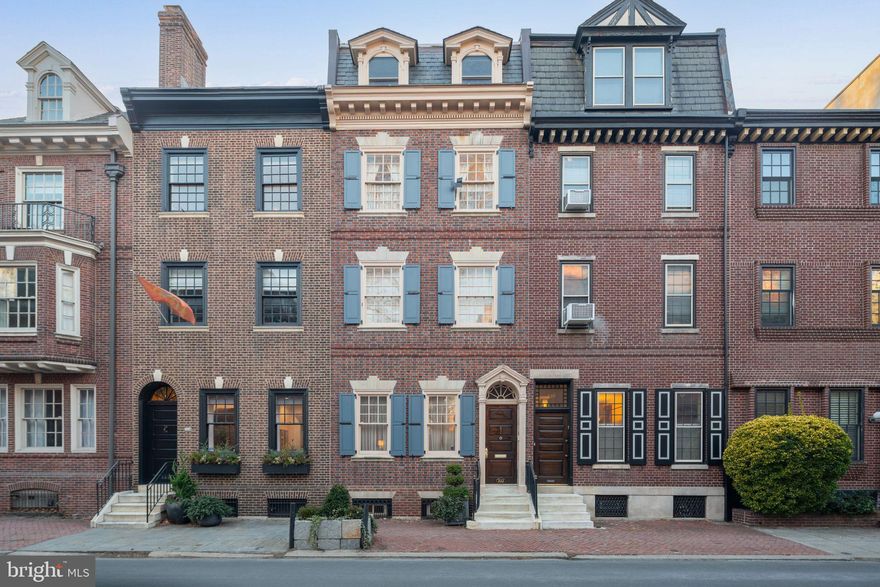 This quintessential historic 1850's Rittenhouse townhome has amazing spaces and charm. There are 4 en-suite bedrooms, 4.5 baths, a large "period perfect" family room with wood burning fireplace and adjacent wet bar room. Other features include a good-sized leafy patio, huge roof deck, elevator, plentiful storage space, including 3 walk-in closets, a pantry and much more. High ceilings, gleaming historic wood floors and period moldings grace this property with gorgeous views down Delancey Street! FIRST FLOOR: Attractive tiled foyer leading to hallway, gracious living room with high ceilings and dining possibilities as well, powder room, pantry, elevator, spacious country eat-in-kitchen with Viking stove top, large island with built-ins. Step out to the patio. Step down to basement. SECOND FLOOR: Front 1st bedroom suite with new bath and walk-in closet. Rear Family room with bay window, fireplace, and adjacent wet bar for entertaining, hall closet, elevator. THIRD FLOOR: Front 2nd bedroom with en-suite bath, closet, and adjoining bonus room that can be used as an office, workout room, etc. Rear 3rd bedroom with walk-in closet, bath, and laundry room. FOURTH FLOOR: Front 4th bedroom en-suite with new bath, huge walk-in closet. Step out to a large rear deck with near by wet bar. ALSO: Full basement with finished home office, storage and new 3-zoned HVAC. Home is approximately 4,000 sq. ft. and in the Greenfield School catchment! This home is versatile and can check a lot of boxes for many Buyers' needs! Bedrooms are all private .......the floor plan is wonderful! One year prepaid parking with an acceptable offer!