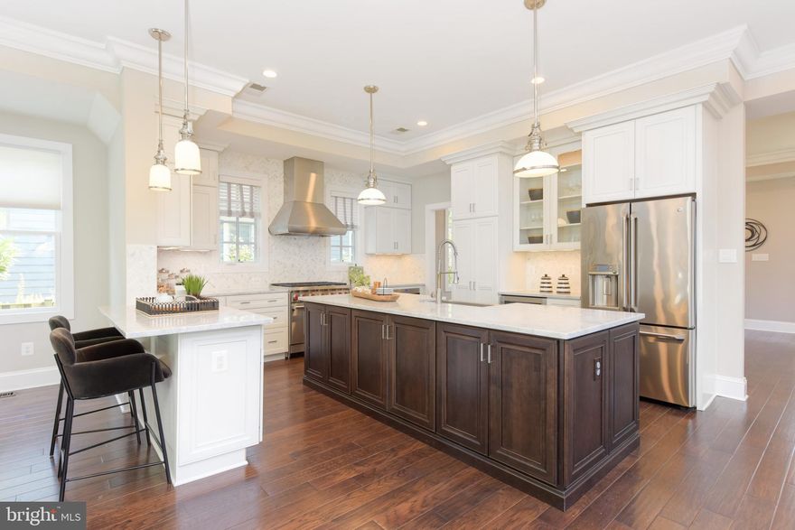 Almost completely new in 2014 - totally rebuilt and renovated... new windows, roof, electrical, plumbing, fixtures, systems, layout - and more. Situated on a corner lot in the heart of Del Ray, this beautiful 4 bed/3.5 bath detached beauty is truly a dream home. Completely remodeled in 2014 and meticulously maintained, prepare to be wowed! A large front porch greets you - enjoy quiet fall mornings sipping coffee and watching the world go by! From the porch, head inside - light and airy with tall ceilings, great lighting and ample square footage - you'll feel like you've stepped into a model home. The dining room flows easily into the kitchen and living rooms. The kitchen is a true chef's dream. Gorgeous Carrara marble countertops are offset with crisp, white shaker-style cabinetry; a six-burner Wolfe range with a commercial hood is flanked by two windows and herringbone-set backsplash. A large island with wood cabinetry provides a great contrast to the neutral whites and grays and anchors the kitchen, which overlooks the bar area and family room. Additional features include a beverage refrigerator, coffee-bar area, ample cabinetry, pantry with custom roll-outs, built-in drawer microwave and more. Great for holidays or everyday living, enjoy appetizers at the kitchen peninsula or clear the space for a day of baking. To the left of the kitchen is a perfect breakfast nook with built-in banquette seating. The living room overlooks a gas fireplace and has ample seating for family and friends! Glass French doors line the rear of the living room and overlook a serene, private stone patio and backyard. Rounding out the main level are a beautiful half bathroom and a rear entry with mudroom cubbies! Head upstairs to a fabulous layout of 4 bedrooms filled with light and 2 full bathrooms. Each bedroom is spacious and has great closet space. Three bedrooms share a hall bathroom and feature tall ceilings, crown molding, ceiling fans and recessed lighting. The primary bedroom is a true retreat. Generously sized to easily accommodate a king-sized bed, this room features a fabulous tray ceiling, two walk-in closets and an en-suite bathroom. You will feel like you are escaping to the spa in the lovely bathroom with oversized shower and double vanity. A linen closet and laundry area round out the home's upper level. Head downstairs to the recreation room which can double as a 5th bedroom. With legal egress, this room could be used for an au-pair suite or could double as a playroom/guest space with a pull-out couch. With amazing ceiling height and light, you don't feel like you are in a basement at all. A conveniently-located full bath can be found on this level as well as a utility/storage room. The fully-fenced yard is a true landscaper's dream. Planned and cared for by a landscape architect, the yard features flourishing limelight and oak leaf hydrangeas, green emerald arborvitae, miscanthus and more - enjoy outdoor entertaining on the patio. The rear of the home also features a detached one car garage. Don't be fooled by the blooming hydrangeas in the driveway - trim these for easy access to the garage to park in the winter months! You could also use the garage as a gym, office - the world is your oyster! With an amazing location, you can easily walk to shops and restaurants in Del Ray - and don't miss Saturday's Farmer's Market in Pat Miller Square. Located close to National Landing - Amazon HQ2 and VA Tech's new campus, this location cannot be beat. Just a 15 minute drive to DC, 8 minutes to Regan National Airport, close to Old Town and more - you will love living at 400 E Bellefonte! Welcome home!