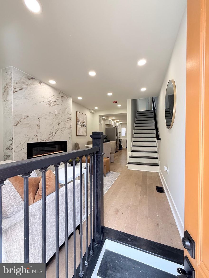 Welcome to Baltimore City Luxury Living at an affordable price! Just minutes from John’s Hopkins, this beautiful 4 level  rowhome boasts custom living on every floor! As you enter, you’re greeted in the living area by a large floor to ceiling ceramic tiled fireplace wall. The gourmet kitchen features stainless steel appliances, upgraded quartz countertops and a custom dual directional faucet with a 9 inch deep sink! The second level hosts 2 bedrooms, a large custom full bath, and a bedroom level laundry! Each bedroom is equipped with closets with custom organizing units for added space. The third level is an owner’s dream come true. The owner’s suite is packed with a dual custom closet, barn door, and an expansive en-suite! The en-suite comes with a double bowl vessel vanity, a large walk in shower, and a tiled picture window feature wall with breathtaking views of the Hopkins City skyline. The fully finished basement is perfect for entertaining and hosting!! One Year Home Warranty! Schedule your private showing TODAY!