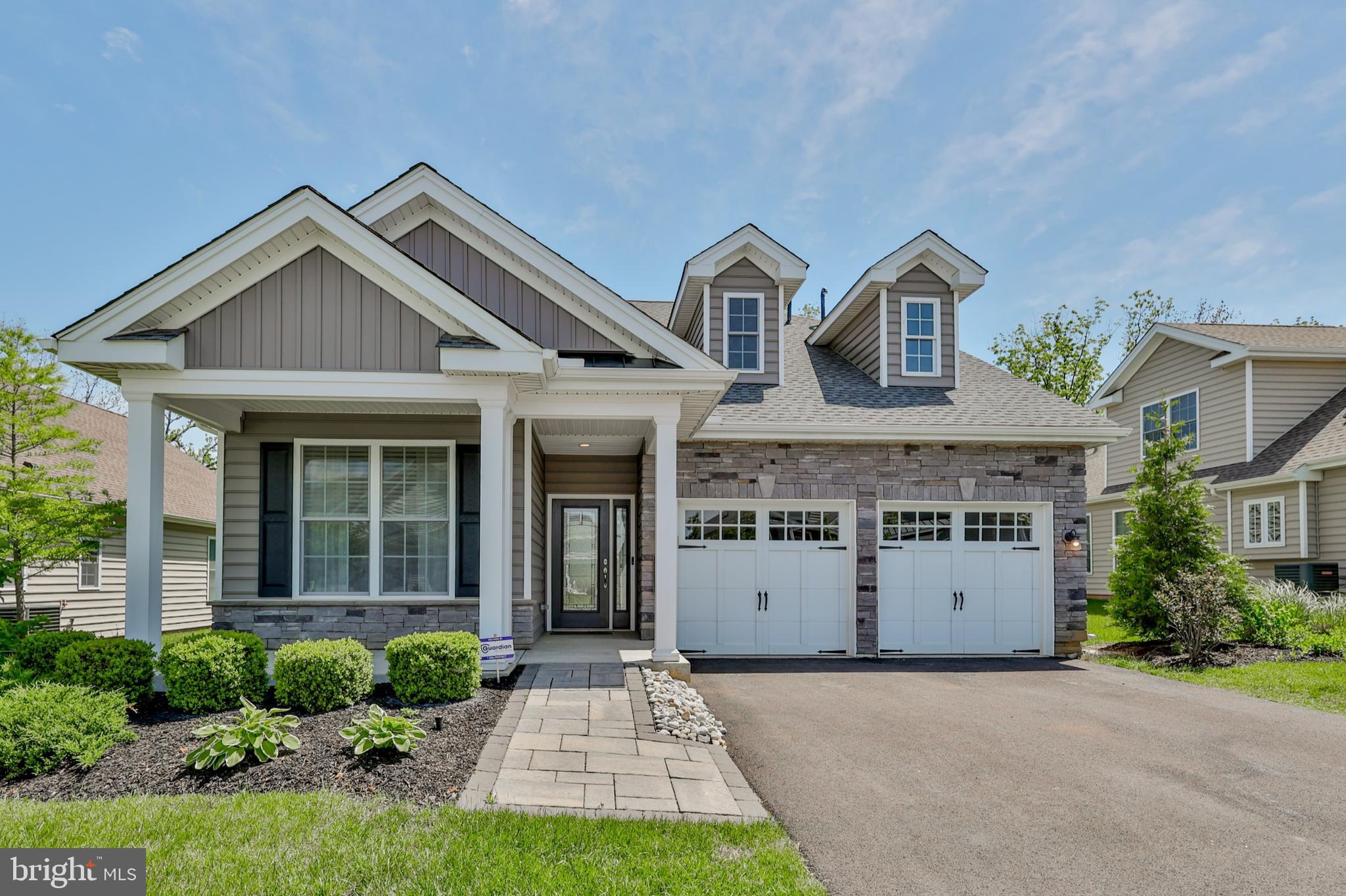 Stunning former model home in the highly desirable 55+ community of Traditions of America – Green Pond! This 3 BR, 3 BA upgraded Betsy Ross model offers elegant design, custom millwork, and engineered hardwood flooring throughout the main level. The chef’s kitchen features an upgraded appliance package, granite counters, and ample cabinetry—perfect for entertaining. Enjoy the spacious living room with a gas fireplace and the bright sunroom with views of beautifully landscaped grounds. The first-floor owner’s suite boasts a tray ceiling, luxurious en-suite bath with heated floors, and a handicap-accessible shower. A second bedroom and full bath are also on the main level. Upstairs includes an extended loft, third bedroom, and additional full bath—ideal for guests or office space. Additional features: whole-home generator, on-demand hot water, built-in sound system, Guardian security system, and irrigation system. Community amenities include a clubhouse with sports bar, fitness center, aerobics room, pickleball/tennis courts, golf simulator, outdoor pool & spa, and more. Enjoy maintenance-free, resort-style living at its finest!