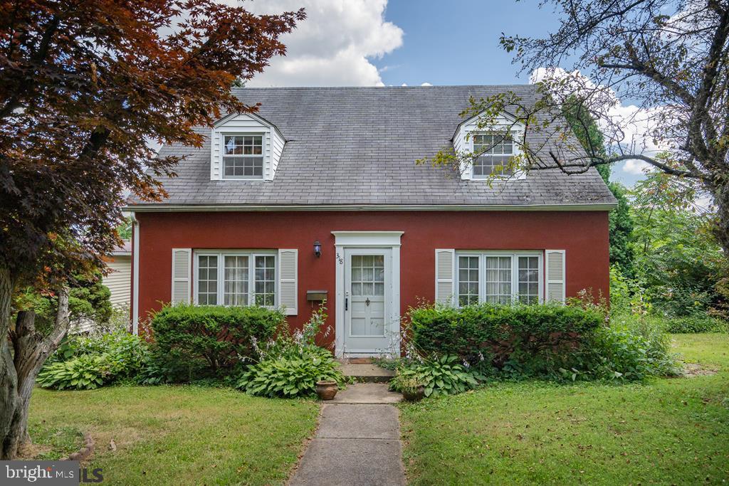 Charming cape cod half a mile to PSU! This sweet home has hardwood floors, remodeled kitchen and baths, and central air. The large, sunny living room is a delight, with plenty of space to gather and a wood-burning fireplace with steam heat insert. Remodeler's Workshop kitchen features solid wood cabinetry extending to the ceiling, beautiful granite countertops, tiled backsplash, gas range, instant hot water dispenser, and a Bosch dishwasher. The kitchen leads to both the lovely dining room and the deck, making entertaining a breeze. Upstairs, the large owner bedroom has a sweet window seat and built in drawers. Two more bedrooms and a full bath complete the second floor. You can leave your car behind in the garage! This darling home is in close proximity to PSU campus, downtown, grocery stores and schools. Gas furnace and central air were installed in 2021.