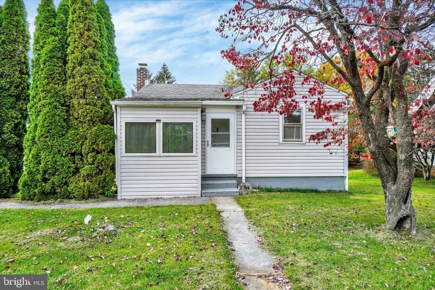 Enjoy the pleasures of small town living in this well maintained and tastefully updated home on a 1/2 acre lot with huge level backyard, just minutes to John Rudy Park, shopping, schools and I-83 access for easy commutes north or south. The welcoming front entry reveals a cozy sun room perfect for relaxing with your morning beverage, new LVP flooring in the living room, hall and bedrooms, updated full bath and renovated kitchen with butcher block counters, oversized bar sink, new water filtration system, ceramic tile backsplash and SS appliances including 5-burner stove and new built-in microwave.  The walk-out basement offers a generous family room with new LVP flooring that could easily be an additional bedroom, plus a large closet/storage area and  laundry room with washer and dryer included. Sliding glass doors open to a huge rear patio with covered pavilion overlooking the peaceful backyard, which features mature trees for shade and privacy, a bountiful vegetable garden and three large sheds for all your outdoor needs. Detached garage with built-in workbench, cabinetry and automatic opener and driveway parking complete this must-see residence. Welcome home!