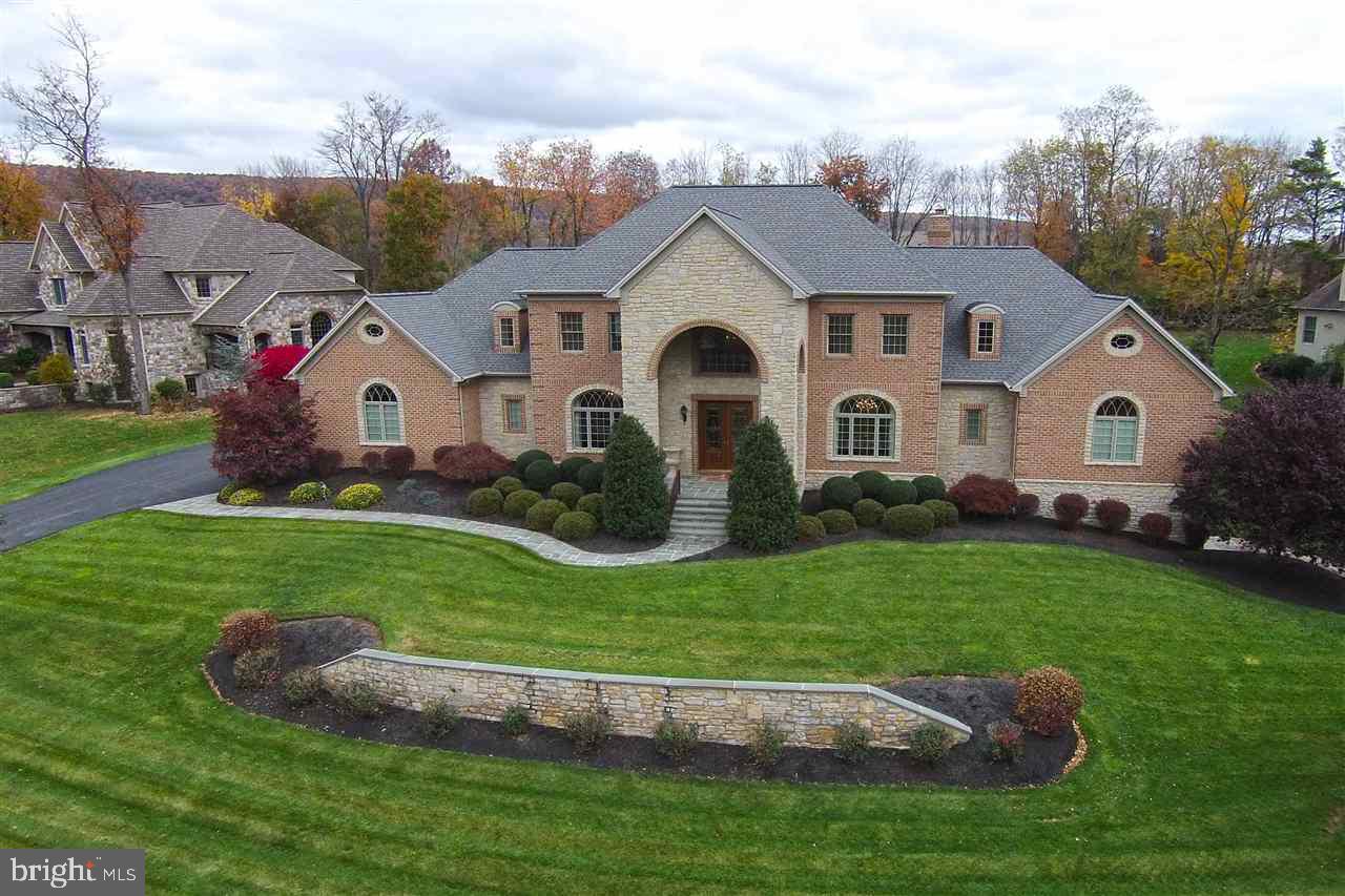 All of the stately grandeur and elegance you would expect from the Pinehurst Development. Custom Tiday built home offers over 6500 sq ft of finished living area. Curb appeal is everything with the handsome brick and stone (no fa ade)exterior that has been thoughtfully planned to expose natural beauty and enhanced with Pella Gothic accent windows. Enter through the handsome mahogany double doors to find the expansive curved staircase in the grand foyer, expect to be WOWED! Find exceptional quality & details.