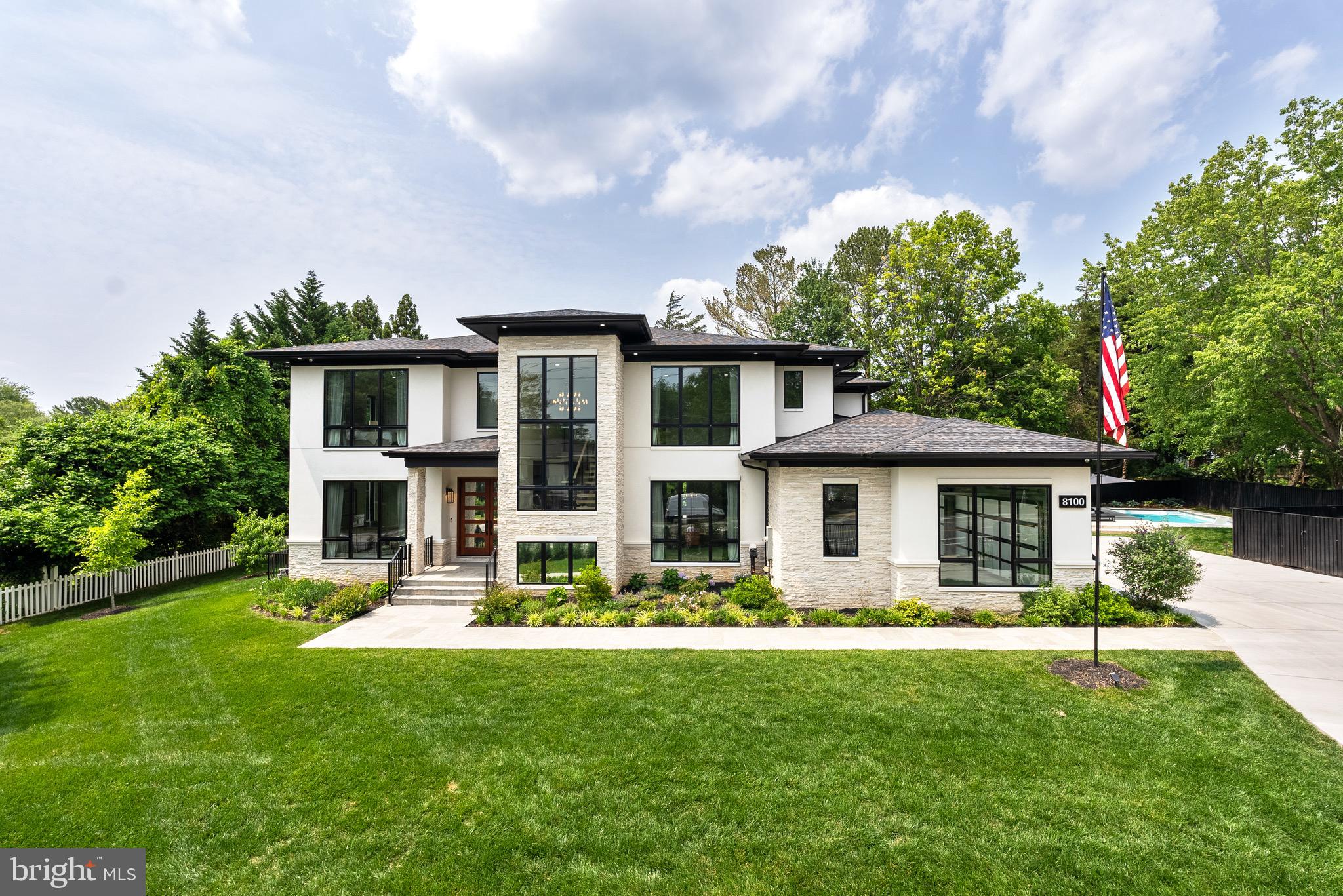 Modern Luxury in the Heart of McLean
Just moments from Tysons Corner and downtown Washington, this impressive modern residence is the embodiment of timeless design and refined living. Originally crafted by an award-winning architectural team, the home has been thoughtfully expanded and enhanced by its current owners to offer more than 8,000 square feet of luxurious living space, enriched by a curated selection of high-end upgrades. Set on a premium site behind a private, gated entry, the property offers a rare sense of privacy and sophistication just minutes from the vibrant center of McLean.
Inside, floor-to-ceiling windows flood the interiors with natural light, highlighting wide-plank imported wood flooring, elevator that services all floors, designer lighting, and bespoke finishes. The open-concept layout creates a seamless flow, ideal for both large scale entertaining and relaxed everyday living.
The chef’s kitchen is a true culinary statement—outfitted with Sub-Zero and Wolf appliances, dual dishwashers, custom German Rehau cabinetry, and a built-in Miele espresso system. The space opens to a sunlit breakfast area and a central family room anchored by a sleek linear gas fireplace, custom built-ins, and walls of glass leading to an expansive stone terrace and landscaped yard—complete with a newly completed, heated pool with a retractable power cover.
A bright home office, versatile guest suite (or second office), a designer mudroom with built-ins, and a full bath/dog wash complete the main level. A dramatic floating staircase introduces the upper level, where generously sized en-suite bedrooms feature walk-in closets, imported cabinetry, and stunning baths. The expansive primary suite is a private retreat with floor-to-ceiling windows, custom closets, a private coffee bar, and a spa-style bath designed to indulge.
The lower level offers 10-foot ceilings and an entertainer’s dream: a custom stone fireplace, wet bar, wine gallery, game area, home theater, large gym, and ample storage.
Outdoors, the private terrace overlooks the expansive green lawn and sparkling pool. The newly completed pool is a perfect summer destination with an adjacent outdoor pavilion featuring a covered bar with whimsical seating and festive lighting. Additional highlights include a 3-car side-load garage with epoxy floors, glass-panel remote-controlled doors, a 230V EV outlet, and room for lifts. Smart home features abound including an electronic entry system, Lutron lighting, in-ceiling speakers, mood lighting, full security camera coverage, an electronic entry, whole-house surge protection, generator pre-wiring, and CAT 5 wiring. Exterior upgrades include new landscape lighting and a full irrigation system.
Located within the area's top ranked Langley High School pyramid, this immaculate residence provides walkable access to the Spring Hill Recreation Center and close proximity to McLean, downtown Washington, and the region's airports. This is a rare opportunity for a discerning buyer seeking exceptional architectural style, modern technology, and turnkey condition in one of McLean’s most desirable locations. All furnishings and decor convey.
