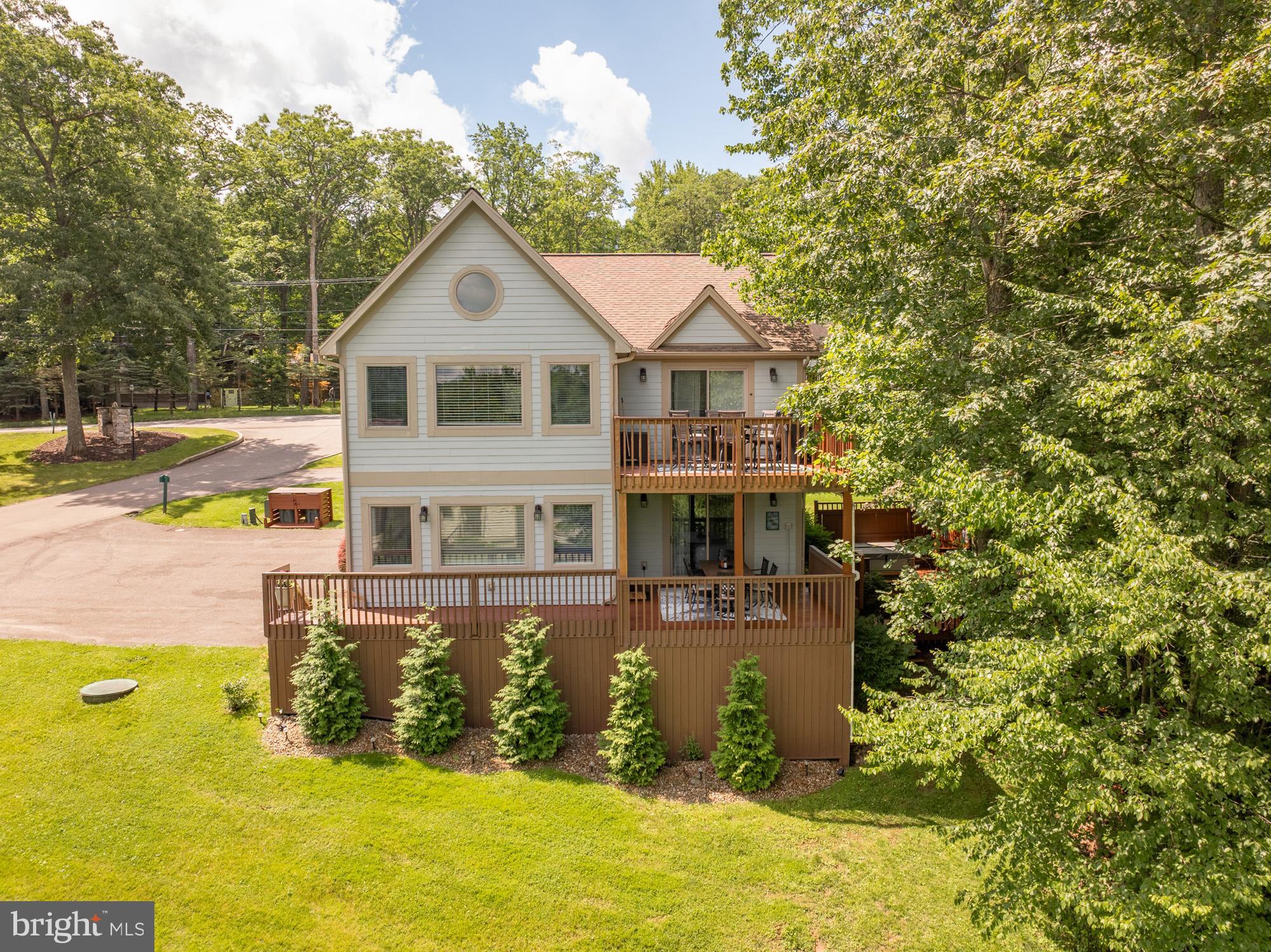 Beautiful lake access retreat located in the Silver Tree Landings community. This recently updated contemporary home feels warm and inviting from the moment you walk in (upgrade list available). Offering hardwood flooring, granite countertops, two stone propane fireplaces and cathedral ceilings. The abundance of windows allows the natural light to brighten any season, while offering views from almost every room. The covered and uncovered decks offer plenty of outdoor space to enjoy with family and friends during any season. If all this isn't enough, take a short walk down to the lake access area, where you can enjoy the lake and everything it offers. The location checks off one more box, just steps to Dutch's Restaurant & Harbor Bar, and minutes to Wisp Ski Resort. Call today to preview this gorgeous home!