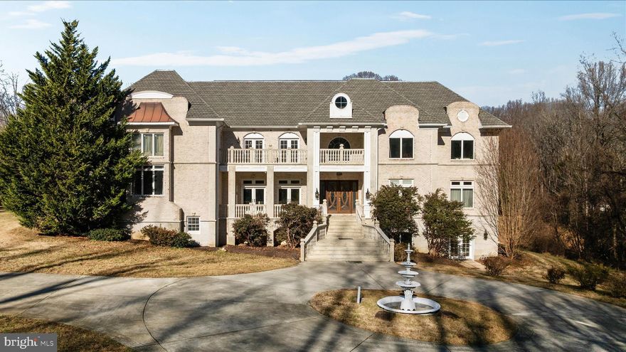 Spanning over 17,000 square feet of meticulously crafted living space, this manor is a masterclass in scale and sophistication where grand architectural ambition meets a surprisingly serene atmosphere. The journey begins at the entrance, where imported Spanish railings and granite stairs lead to a brick and granite facade that exudes timeless beauty. This exterior is further distinguished by four granite balconies adorned with architectural balusters meticulously crafted from a blend of limestone and granite, a theme of "granite galore" that continues throughout the entire estate.

Inside, the home unfolds across soaring spaces anchored by rich Brazilian Cherry floors and a commitment to meticulous craftsmanship. The first floor establishes a sense of grounded majesty with its 10-foot ceilings, while exquisite case moldings wrap every room in a layer of polished, traditional elegance. The formal living room and a separate family room command attention with nearly 20-foot ceilings and two imposing gas fireplaces, framed by towering walls of glass that invite natural light to flood the interior, further enhancing the home’s vibrant, airy feel.

The heart of the home is a true epicurean’s dream, featuring a professional-grade kitchen equipped with a six-burner Wolf stove, Dacor and GE Monogram appliances, and a centerpiece granite island with a prep sink. This culinary hub is flanked by a sprawling breakfast room, a built-in Dacor coffee station, and a high-capacity refrigerator and freezer set. Nearby, a unique mudroom with its own fireplace—one of five fireplaces throughout the estate—offers a cozy transition from the epoxy-flooring in the garage. In total, the home provides a 5-car garage capacity, consisting of a 2-car attached and a 3-car detached garage, ensuring ample space for a private collection. The main floor also hosts a private office and a breathtaking two-story library, complete with a dedicated art and portrait gallery on the level above.

The primary suite is a sanctuary of staggering proportions, encompassing over 1,776 square feet on the main level. This retreat features a vast sleeping chamber, a dedicated sitting area, an expansive walk-in closet, and a spa-inspired ensuite bath with a steam shower, separate tub, and water closet. Moving to the second floor, where 9-foot ceilings maintain an open and airy atmosphere, the grandeur continues with four additional oversized bedrooms. Each is a suite with its own private bath, with three leading out to private granite balconies that showcase the intricate limestone and granite architectural balusters. These rooms center around the upper mezzanine and are connected by extra-wide hallways that maintain the home's sense of openness. For added practicality, the home features laundry facilities on all three floors and an inspected, install-ready elevator shaft.

The fully finished lower level, which also boasts impressive 9-foot ceilings to avoid any subterranean feel, is an unparalleled destination for wellness and recreation. It features a full-scale 960-square-foot professional gym and a comprehensive spa area with a sauna, steam shower, and multiple showers, all with easy access to your private inground pool and a wine cellar. Entertainment options abound with a large media room and several recreation rooms, perfect for hosting significant gatherings.

This forward-thinking estate is rounded out with an energy-efficient geothermal system and sustainable solar panels, ensuring that while the lifestyle is grand, the home remains efficient and modern, with average utilities staying under $300 per month. It is a masterpiece of architectural precision and positive energy, standing as a generational sanctuary where every molding and granite detail provides a life of quiet prestige and absolute comfort.