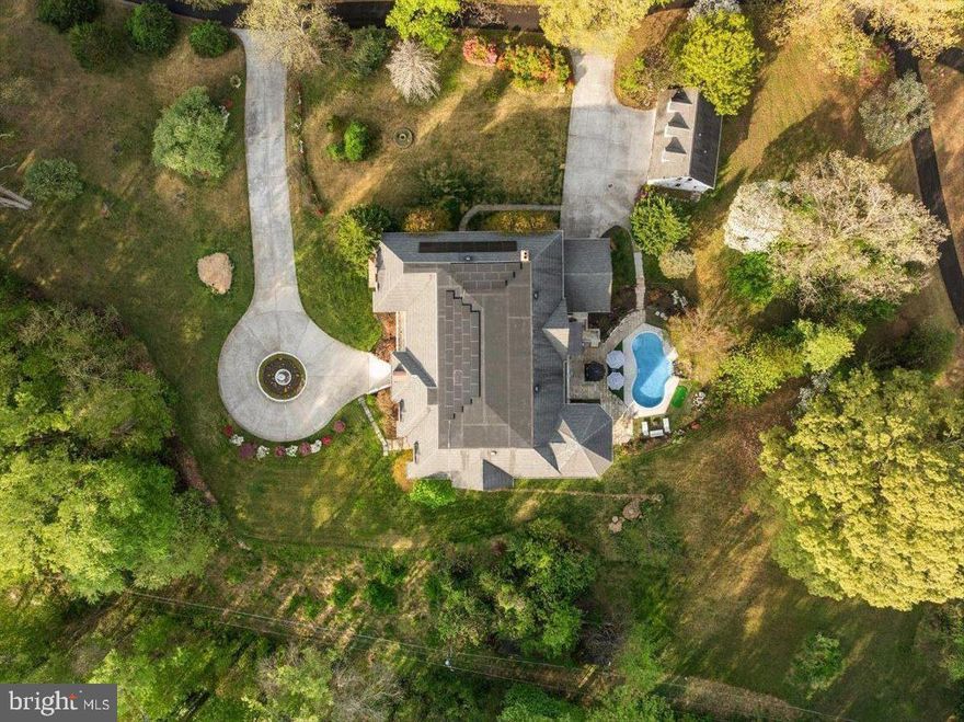 This extraordinary home manages to do the impossible: it offers over 17,000 square feet of architectural brilliance while maintaining incredible warmth and intimacy. While the scale is undeniably grand, the floor plan is a masterclass in human-scale design, prioritizing an unhurried flow and everyday livability. From the moment you arrive, the imported Spanish railings and brick-and-granite façade establish a sense of enduring quality, yet the layout ensures that the first impression is as inviting as it is stately.

The brilliance of the interior lies in its intentional proportions. While the formal spaces command attention with soaring 20-foot ceilings and towering walls of glass, the home never feels cavernous. Rich Brazilian Cherry hardwoods anchor each room, creating a grounded atmosphere that balances the dramatic volume of the formal living and family rooms. Here, the architecture invites natural light to fill the space, ensuring that even the most impressive rooms feel airy and inherently comfortable.

The primary suite is a true sanctuary, spanning over 1,750 square feet to offer a private wing for total decompression, complete with a sitting area and a spa-inspired bath including a steam shower, dual vanities & deep jetted tub. 

A grand beautiful office overlooking the front yard greets you just off the foyer.

At the heart of the home, the kitchen and family room transition seamlessly for a layout designed for true connection. Though equipped with premium appliances for serious entertaining, the space remains centered on daily life, featuring a generous breakfast room and a built-in coffee station for slow mornings. Thoughtful touches like a fireplace in the mudroom—one of five throughout the estate—ensure that even utilitarian transitions feel cozy. This wing also includes a dramatic two-story library, topped by a dedicated art gallery that keeps the home’s creative spirit visible and accessible.

The upper levels prioritize the luxury of space and privacy, connected by extra-wide hallways that make moving through the home feel effortless. Each secondary bedroom is a full suite with its own private bath, and three feature granite balconies for private outdoor escapes. Practicality is woven into this grand design, with laundry facilities on all three floors and an elevator to simplify the logistics of daily life.

The lower level defies expectations of a basement offering a bright, open-concept wellness and entertainment hub that feels like a private club. A 960-square-foot professional gym anchors the wing, sitting alongside a full spa with a sauna and steam shower. With direct access to the private inground pool, the transition between indoor wellness and outdoor recreation is seamless. Between the wine cellar, media room, and multiple recreation spaces, the floor plan provides an intuitive flow for both large-scale hosting and quiet family indulgence.

Perhaps the most comfortable aspect of this estate is the peace of mind provided by its forward-thinking infrastructure. A sophisticated geothermal heating and cooling system paired with solar panels allows the home to operate with incredible efficiency, keeping average monthly utilities under $300. It is a rare achievement to find a residence that offers the grandeur of a palace with the manageable footprint and sustainable ease of a modern home. This is a generational statement built for legacy, where every square foot is designed to help your life unfold with total ease.  *** Fully Inspected Elevator Shaft in Place - Elevator to be installed prior to settlement
