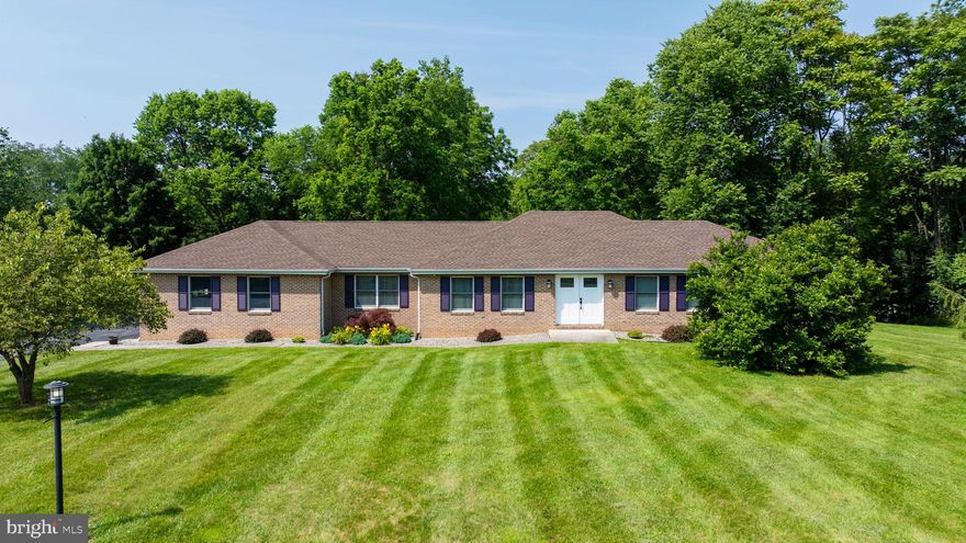Welcome to this stunning brick rancher offering exquisite one-level living on an expansive, flat lot lined with mature trees for privacy and peaceful views. Thoughtfully updated, this home features a newly renovated kitchen with modern finishes. Upgrades included new stainless steel appliances, Kraftmaid cabinetry with pull-outs, quartz countertops and flooring.  Both bathrooms were also beautifully remodeled, providing both style and comfort for all occupants and guests. 

Relax and enjoy your morning coffee in the charming screened-in rear porch or entertain with ease in the spacious living and dining areas. The full, finished basement offers endless possibilities for future expansion—think guest suite, rec room, or home office. A separate mudroom entryway from the garage provides a designated space for the washer/dryer, which were replaced in Nov. 2022.

The oversized two-car garage provides ample room for vehicles, tools, and extra storage. With a new well pump in April 2025, a new HVAC system in Nov. 2018, new lighting fixtures/ceiling fans throughout the home and so much more, this home truly blends timeless construction with modern upgrades, all nestled in a serene, established setting. Don't miss this rare opportunity for convenient, comfortable, and stylish one-level living!