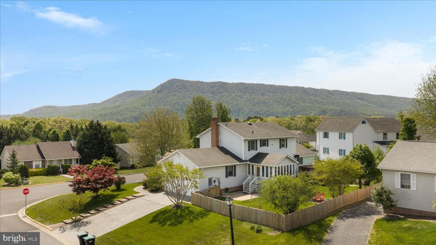 Bright and inviting home on a corner lot with mountain views and excellent curb appeal. This spacious two-story offers 4 bedrooms and 3.5 baths, including a convenient main-level primary suite for easy living. The main level features a warm and welcoming living room with a cozy gas stove, a comfortable family room, a formal dining room, and a kitchen with table space ideal for everyday meals and gatherings. The sunroom fills with natural light and provides a perfect spot to relax and enjoy the surrounding views.

Laundry is conveniently located on the main level, with an additional laundry area in the partially finished basement, offering flexibility for multi-generational living, hobbies, or extra workspace. Step outside to enjoy the covered front porch or entertain in the fenced backyard, complete with an above-ground pool and storage shed. An attached two-car garage adds everyday convenience. The A/C's are newer than 5 years old, and the backyard fencing is 2 years old. 

A wonderful combination of space, functionality, and outdoor enjoyment—this home is ready to fit a variety of lifestyles.