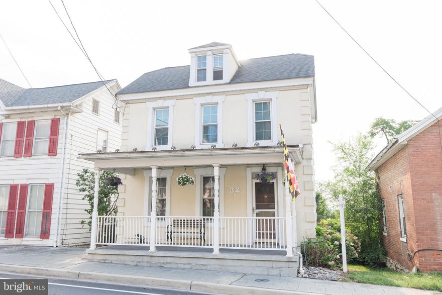 Welcome home! Enjoy the past and present in this charming colonial right in downtown Union Bridge.  The main floor features hardwood floors, foyer, powder room, living room, step down into the cozy dining room area featuring a wood pellet stove. Continue your tour and enter the spacious eat-in kitchen with island. From the kitchen you have a choice to walk up the additional staircase to the upper level or step onto the oversize deck, (deck furniture conveys) to enjoy the view of the large backyard featuring fence and privacy trees. There is a very large garage with electric that offer space for at least four cars or equipment!  Another feature off the kitchen is a convenient side porch. The upper level features a cozy reading nook, updated full bath and 3 bedrooms, some with built-ins. Solar Panels are on the detached garage. Schedule your showing today!