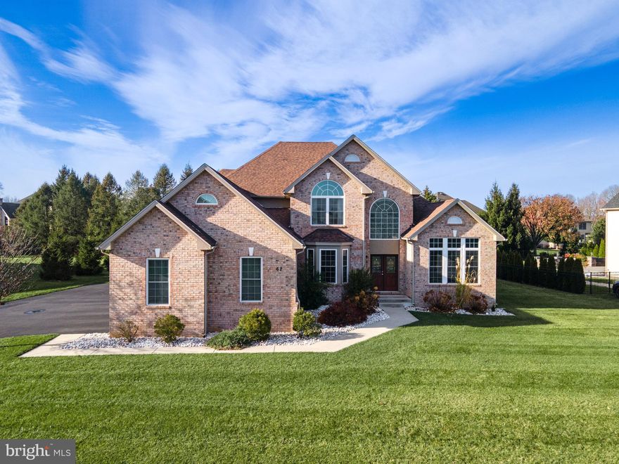 Experience luxury in this 4-bed, 3F/2H bath full brickfront Colonial in prestigious Parkview Estates. A grand 2-story foyer w/palladium window & curved wrought iron staircase sets the tone. HW floors span the main level, leading to a vaulted formal LR & an elegant DR w/crown molding, chair rails, & a bump-out window. The split FR feat a double-sided gas fireplace—one side w/built-in speakers & a bump-out window for a home theater experience, the other a dramatic 2-story space w/sliding door access to the backyard. The upgraded kitchen offers granite counters, mosaic backsplash, stainless steel apps w/wall oven, recessed lights, pantry, oversized island w/pendant lighting, & a bright breakfast nook w/outdoor access. A butler’s pantry/wet bar adds convenience. The 1st-floor master suite includes carpet, crown molding, his-&-hers closets (one walk-in), & a spa-like bath w/double vanities feat a sitting area, tiled garden tub, tiled walk-in shower, & private commode. Upstairs, the hallway overlooks the foyer & FR. All bedrooms offer carpet & ceiling fans; the princess suite has its own full bath, & 2 add'l bedrooms share a tiled hall bath. The fully finished basement provides a large recreation area w/LVP floors & a 1/2 bath. A 3-car side-entry garage & level backyard w/a dedicated pet area complete this exceptional home. Close to US-22 & PA-33, Palmer Comm Pool, Hackett Park Disc Golf Course, Palmer Park Mall, Easton Public Library, shops, restaurants & more!