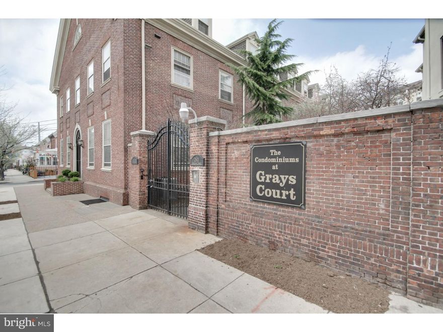 An incredible blend of contemporary upgrades with historic flare.  Fall in love with this 2BD/1.5BA unit at the Carriage House in the sought-after, gated Gray's Court community!  Step inside to a sweeping open floor plan, lined with pristine wood floors, extra-large windows, fireplace, and French doors leading to a quaint outdoor patio.  Enjoy a state-of-the-art kitchen with Stainless Steel appliances & granite island/breakfast bar, plus plenty of room for a designated dining area.  Your spacious Master includes fresh carpeting, oversized windows, and 2 walk-in closets.  Enjoy added space & storage with additional large bedroom, and laundry/utility room.  Unit includes assigned 1-car parking   easy access to 95 & 76.  Just steps to Naval Square, the Schuylkill Banks Boardwalk & trail, University City & Rittenhouse Square! Schedule your showing today!