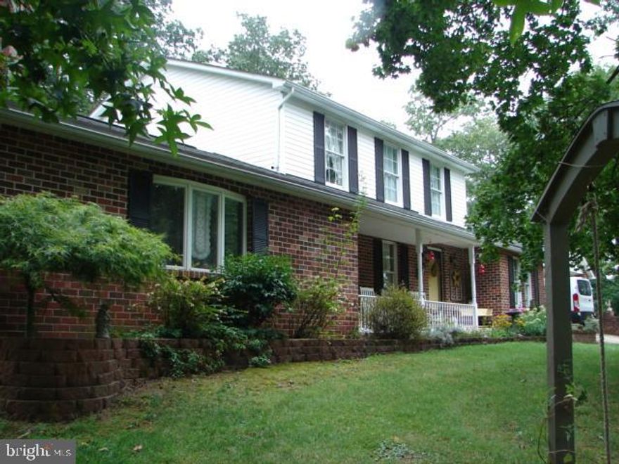 Secluded setting for this charming 3 bedroom, 2.5 bath home on 8+ acres gives your family plenty of space to enjoy outdoor activities or just enjoy the quiet setting of sitting on the front porch or the massive deck with hot tub after a busy day.  Inside your find plenty of room for entertaining friends and family.  The family room, 24 x 24,  features a large wood burning fireplace and cathedral ceiling on the first floor.  In addition, there is a den/ home office space, 12 x 24,  out of the traffic flow and a separate breakfast room /library just off the kitchen. Laundry room is on the main level also.. The foyer and kitchen   have tiled flooring. (dishwasher has been removed, but there is still sufficient cupboard space to add one .)  Upstairs is home to three bedrooms, including owners suite with bath and a shared bathroom for the other two bedrooms.  Basement is partially finished into a game room.  Recently added is a underground electric dog fence,  newer siding, roof,  gutters, and heat pump  were replaced on the house in the last several years.   24 x 24 attached carport and a 24 x 40 POLE BARN WITH ELECTRIC & CONCRETE FLOORING- use for storage, hobbies and/or workshop. Septic pumped this year.    Home selling "as is". PLEASE RESPECT THE SELLER'S PRIVACY - DON'T DRIVE BACK THEIR DRIVE UNLESS YOU HAVE AN APPOINTMENT TO VIEW THE PROPERTY!