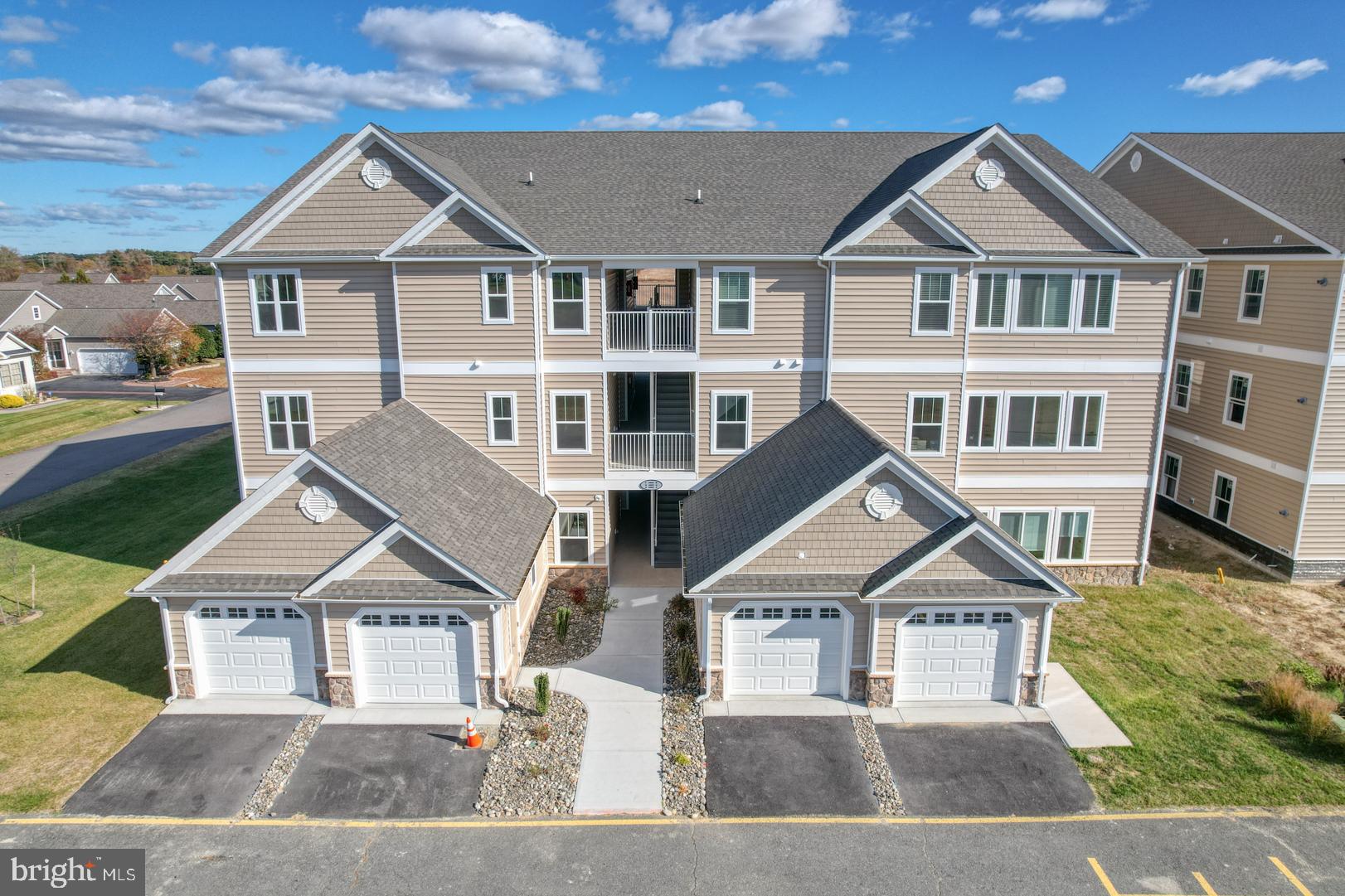 NEW CONSTRUCTION CONDOS, complete and ready for immediate delivery! This unit is a 2 bedroom 2 bathroom unit on the third floor with vaulted ceilings, high quality finishes, and a beautifully open floorplan. The bedrooms are both spacious and truly both function as primary suites. Discover community living in the serene peaceful setting of Hearthstone Manor. The entire community is beautifully landscaped and features multiples ponds and walking trails. The well designed clubhouse features meeting and gathering rooms, a kitchen, full bathrooms, and best of all a COMMUNITY POOL! Enjoy events with fellow residents and entertain your guests all at this community “hub.” Hearthstone is a PRIME location- adjacent to the new Bayhealth Hospital, Sussex Campus, and Route 1 in less than a minute from our entrance. You are just minutes from vibrant downtown Milford, and all the Delaware beach towns- without the price tag. Enjoy the quality of Country Life Homes - a local family-owned builder with a deep commitment to Milford and the surrounding area. Builder paying $5,000 Capital Contribution for limited time. Occupy your unit and enjoy maintenance free living - or purchase as a sound investment property in the exciting and growing southern Delaware region. Stop by one of our open houses or contact us today for more a full list of amenities or to schedule your private appointment and become a part of Hearthstone today.