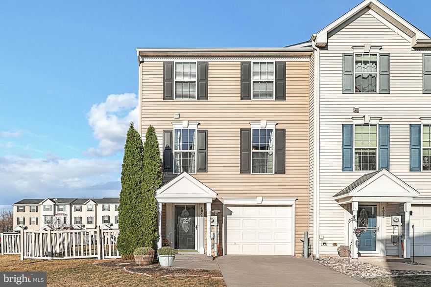 This end-unit townhome has a new architectural shingle roof. A new added patio and roof over the patio makes for a cozy place to spend your spring, summer and fall evenings. As you enter the open concept home there is an eat-in kitchen with an island that leads to the spacious living room and a convenient half bathroom.  Off the kitchen is a large deck ready for grilling.  The next floor houses the primary bedroom big enough for a king bed. A primary bath along with another full bath and 2 other bedrooms complete the upper level.  The lower level is completely finished with a laundry area and sliding doors that lead to the covered patio.  There is also a one-car garage and a parking space just outside of the garage.  The back of the house has a vinyl fenced in yard with lots of space to play and entertain.  This kind of house doesn’t come up often!  Check the last few photos for a floor plan!