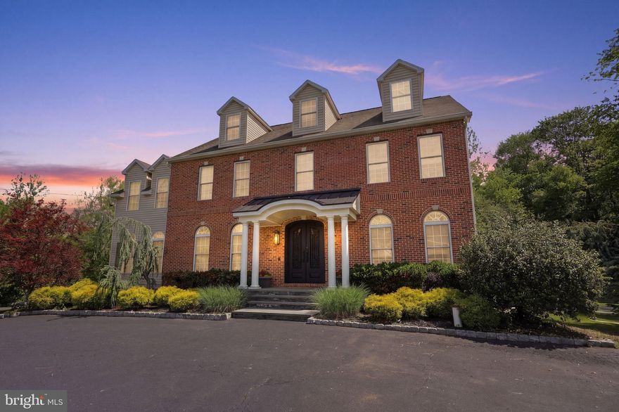 Stunning Colonial located in the highly sought-after Council Rock School District, offering exceptional space, versatility, and elegant design throughout. A grand foyer welcomes you into the traditional center hall layout, flanked by the formal living and dining rooms. The formal living room showcases a tray ceiling, custom built-ins, and a decorative fireplace, while the dining room provides convenient access to the kitchen, perfect for entertaining.

The beautifully updated kitchen features white cabinetry, dark granite countertops, built-in stainless steel appliances, a spacious dining area, and a large pantry. The adjoining family room impresses with a custom coffered tray ceiling featuring layered architectural details that create a sophisticated yet modern feel. Just beyond, the sunroom offers the perfect place to relax while overlooking the lush, scenic grounds and surrounding nature. A full bathroom and laundry room complete the first floor.

Upstairs, the spacious primary suite offers a walk-in closet and luxurious en suite bath with a soaking tub, separate shower, coffered ceiling, chandelier, and linen closet. Three additional bedrooms and a full hall bath provide plenty of room for family and guests. One bedroom even features a unique loft space accessed by full stairs—ideal for storage, a reading nook, playroom, or additional flex space.

The fully finished basement is truly impressive and offers endless possibilities. One side is designed for entertaining with ample space for a media room, play area, game-day gatherings, and bar setup. The other side functions as a private in-law or au pair suite complete with a kitchenette, bedroom, full bath, living area, and private access to the outdoor patio. With direct access from the rear driveway, this space allows for convenient one-level living with no stairs required.

Adding even more flexibility, the property includes a detached two-car side-entry garage with a finished upper-level loft featuring its own split-system HVAC and full bathroom, perfect for a home office, studio or gym.

The outdoor setting is equally beautiful, bordering open Township property and providing peaceful, picturesque views. This remarkable home offers luxury, functionality, and endless opportunities for multigenerational living, entertaining, and everyday comfort.