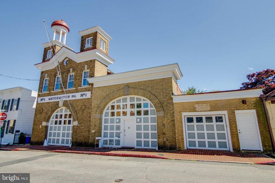 The Waterwitch H&L #133 East Street, aka  The Waterwitch Hook and Latter Fire Station  is one of the most iconic historic structures in the Historic District, and the oldest standing firehouse in Annapolis.  Built in 1913, on the same site as the original fire station built in 1885, the Italianate-style building was occupied by the all-volunteer Waterwitch fire department until 1986, when the firefighting unit was transferred to the new Central Fire Station on Taylor Avenue after 100 years of service on East Street.Today, the Waterwitch is home to two unique luxury condos.  Unit #2 is comprised mainly of the nearly 1,700 sqft second floor of the original two story brick structure with corner towers rising above the roofline, and a large arched opening originally designed for the fire trucks, but now serves as a shared garage for the two units.  The unit features 2 bedrooms with en suite baths, a home office/den, open kitchen/dining/living space that is ideal for entertaining, a private roof deck overlooking the beautiful architecture of the Calvary Memorial Baptist Church and ample storage space.The light filled unit features hardwood floors throughout, high ceilings, open kitchen with granite counters and cherry cabinets, home office/den with access to the roof deck, coveted garage parking with automatic sliding garage doors, a private elevator, and it s unmatched historic charm, make The Waterwitch H&L one of the most unique lifestyle opportunities available on the market today in downtown Annapolis.  It s location is ideal as it sits on a low traffic street, but it s within 3 blocks of city dock, the Market House, Gate 1 of the USNA, the historic William Paca House, the historic Brice House, story-book charm of Maryland Avenue, the State House and all of the bars, restaurants, shopping and landmarks that make up the Historic District.  Short term rental limited to 6 month minimum per condo docs.  See condo docs in documents.  For more details on the history of the structure, ask your agent to pull the historical documents from the MLS.3D TOUR is available here: https://my.matterport.com/show/?m=R4bBsKHxNHD