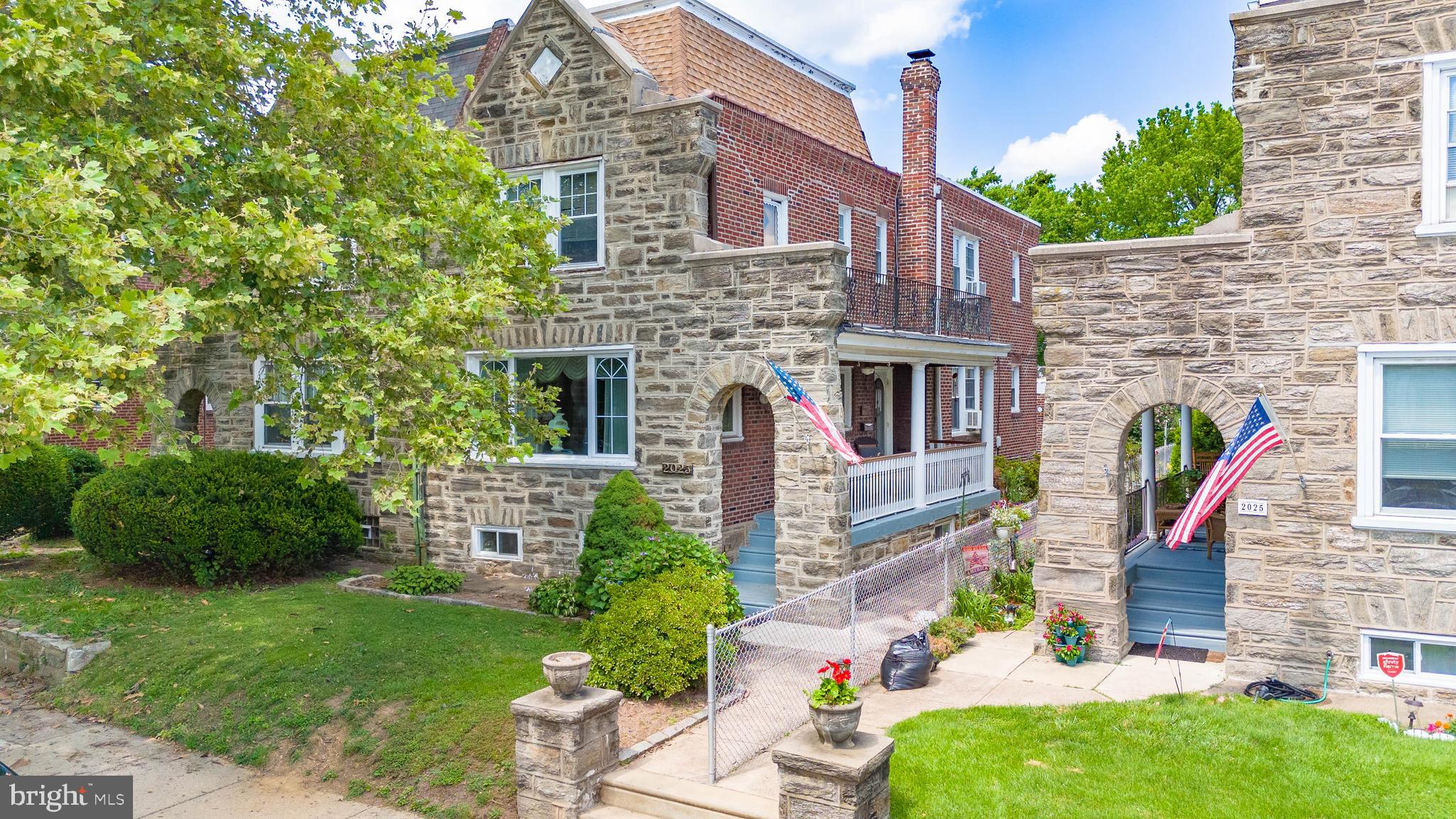 Charming 4BR/2.5BA Korman-style twin on a quiet street in Rhawnhurst with finished 3rd story bedroom, newer rear concrete patio, and one-car detached garage! This inviting stone home features a covered front porch with stained wood ceilings, arched entryway, grand living room with gorgeous decorative brick fireplace featuring stained glass cabinetry & custom wood mantel, crown molding, hardwood flooring with inset border, and radiant heat. Formal dining room with ornate wainscoting, eat-in kitchen with wood cabinetry, granite countertops, electric range, and access to rear patio and detached garage. Follow the beautiful turned oak staircase upstairs where you’ll discover 3 spacious bedrooms, including an owner’s suite with private Full Bath and access to the balcony over the covered front porch, plus a finished 4th bedroom/loft on the third level. Cozy finished basement with half bath, laundry, and utility closet. This home has been lovingly cared for by its current long-time owner. NEW concrete in the rear patio area which leads to the convenient detached garage. Backs to Rhawnhurst Elementary School so no neighbors in the rear of the home. Come see this beautiful home while you still can!
