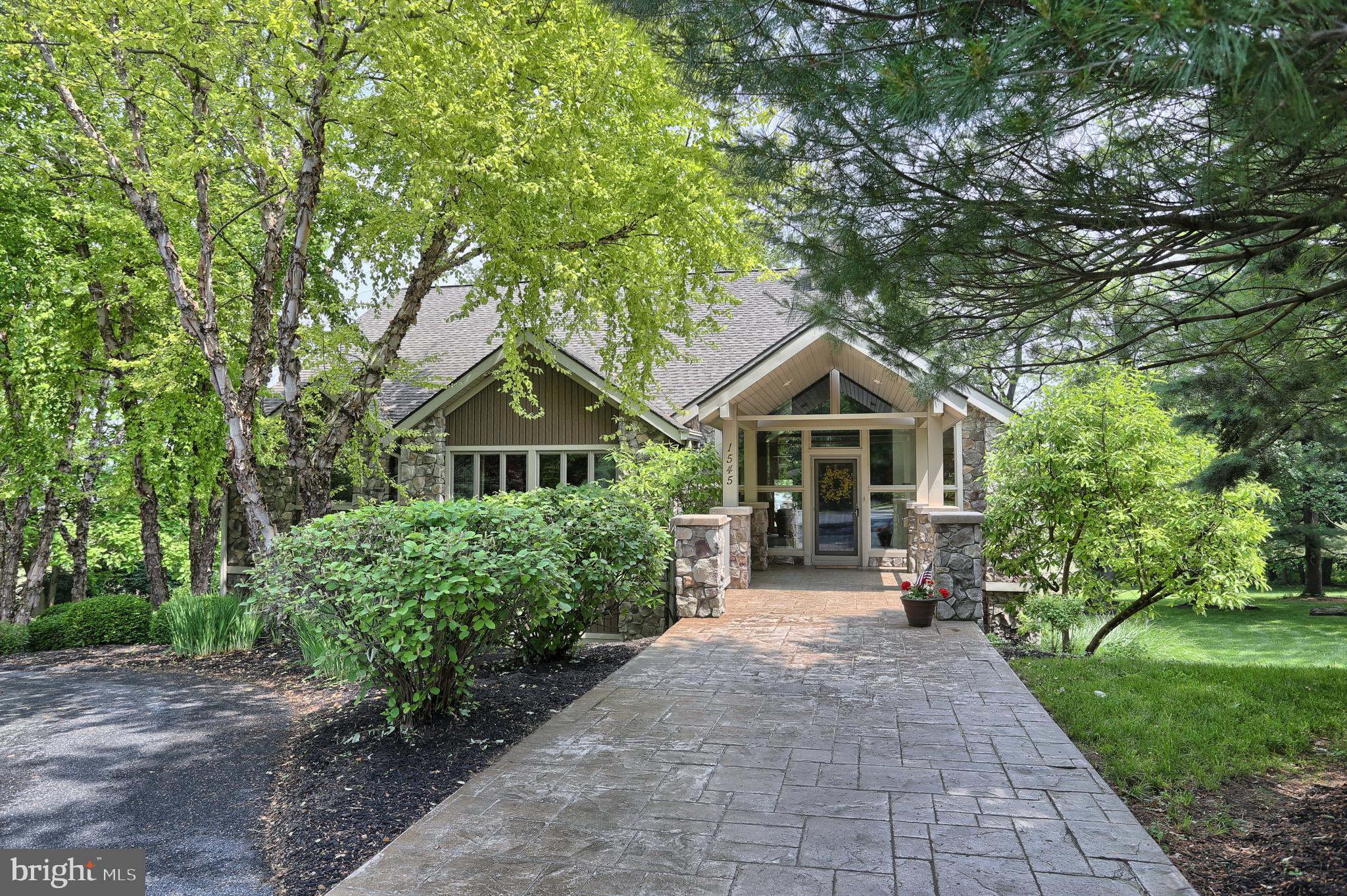 MUST SEE TO APPREICIATE THIS RARE FIND!Architect-designed custom home with open layout to enhance natural lighting with spacious one-floor living in mind.  Upon entry, the vaulted living space with wood plank ceiling, floor-to-ceiling fireplace & waterfall sculpture will impress you and set the tone.  Custom kitchen w/many thought-out upgrades including specialty drawers, peninsula, countertop-matching table & chairs and a freezer with cabinet overlay, to name a few.For a quiet retreat, head to the luxurious English library featuring mahogany floors, dark cherry shelving, detailed moldings and cabinets including file drawers built in on three walls. Would also make an ideal office!The Master suite is expansive - dual walk in closets, fireplace, window seat and more built-ins including desk, shelves and drawers.  Master bath includes jetted tub, separate shower & double sink.The walkout lower level offers a  workout or bonus room  and two large additional bedrooms with full size windows allowing plenty of light - one with walkout patio access & bath to cheerfully accommodate guests.Enjoy peaceful views of farmland from the deck or patio, mature trees on the professionally landscaped  .5 acre lot, a 3-car garage with sensor-controlled lighted driveway. Custom features abound, too many to mention.  Add this to your  MUST SEE  list to experience for yourself.