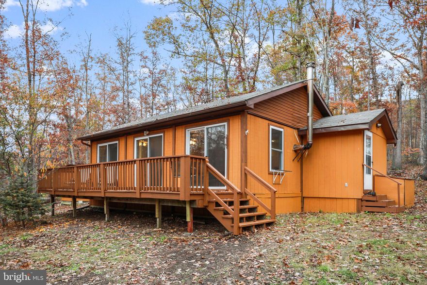 Don't miss this one! Move -in  ready cabin situated on 5 acre wooded lot, with private community access to the Cacapon River.  2 BR, 1 full bath cabin features an open floor plan, brand new roof, flooring , exterior and interior paint. Perfect for a weekend getaway or full time residence.  Call today for your viewing!