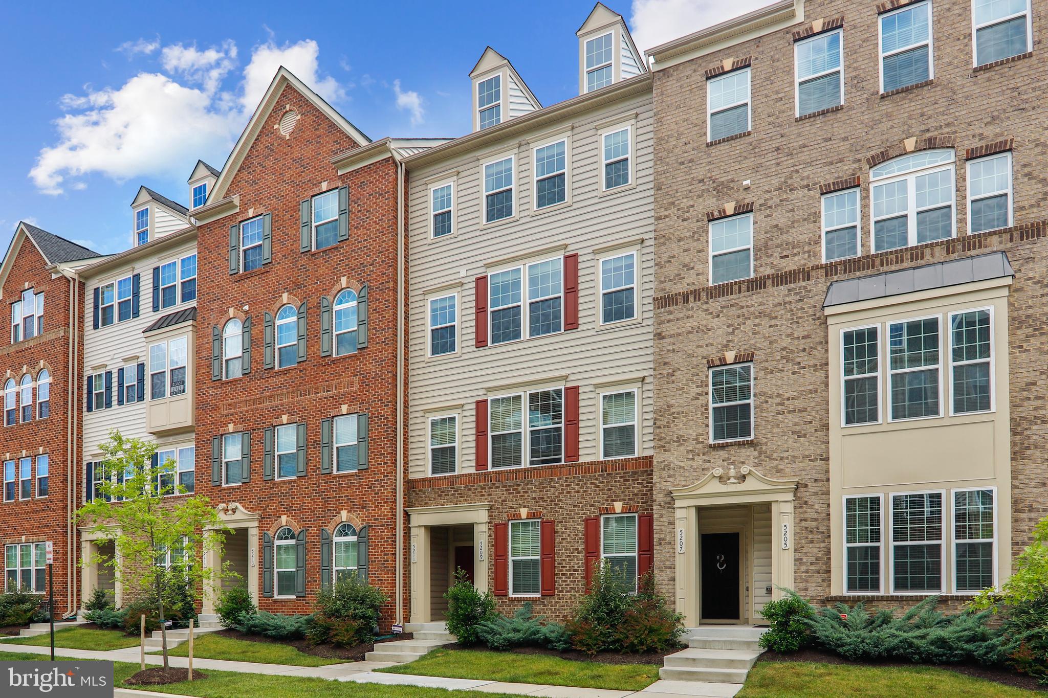 Welcome to The Vistas at Greenbelt Station, one of the finest planned communities in all of Prince Georges County, featuring their premier “Picasso” model townhome condo. This fantastic, only 8-year young, home was built by NVR and features 2,600 square feet of finished space in addition to an attached garage! The heart of the home is the spacious, open-concept design, combination kitchen, dining and family room with built-in surround sound speakers. You’ll immediately be drawn to the rich hardwood floors that carry through this space and are in perfect contrast with the absolutely stunning kitchen that is light and bright! Featuring 42-inch white cabinetry, granite counters, subway tile backsplash, stainless steel appliances, gas cooking, a huge 8-foot island with breakfast bar seating and large pantry, this kitchen is a chef’s dream. A wall of windows, showcasing one of the community’s better views, 9-foot ceilings and patio directly off the kitchen help to bring in tons of natural light, and is the perfect space at the end of the day to relax with your favorite drink. On the opposite end of the main level is a very large flexible space with endless possibilities; living room, game room or office space, ready to suite your vision. A spacious powder room completes the main level. The upper level presents a massive primary bedroom suite that features a tray ceiling, crown molding, sitting area and 2 walk-in closets! The en-suite bath boasts a large walk-in shower with tile surround, bench and a frameless glass door, as well as two separate vanities that are perfect for busy schedules. Two more sizable bedrooms, an additional full bath with dual vanities and very convenient laundry space with built-in storage complete the upper level. Enjoy walking and biking trails, playground, community park and complimentary shuttle to Greenbelt Metro Station. Conveniently located to shopping and restaurants, University of Maryland, DC and all major commuter routes. Stop by and fall in love with all that this amazing home has to offer, and make it your very own!
