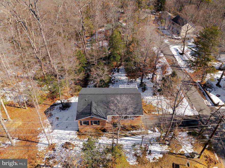 Don’t let the exterior fool you,  this rambler with a walkout basement lives larger than it appears. Situated on a desirable corner lot on Catalina near the community entrance, the home sits on an expansive .687-acre lot (29,914 sq ft), created by combining two original parcels into one oversized homesite, offering extra space, privacy, and flexibility that’s hard to find. Inside, the main level flows comfortably between the living, kitchen, and dining areas, featuring three well-sized bedrooms and two full baths, including a primary suite. The walkout basement with rough-in plumbing adds tremendous potential for additional living space, a recreation room, guest area, or future expansion. Recent updates include a brand-new stove and dishwasher, new hot water heater, new flooring in the kitchen and baths, and fresh paint throughout most of the home (excluding 2 bedrooms). A newer roof and gutters provide added peace of mind. The wraparound deck extends your living space outdoors—perfect for relaxing or entertaining. Located in a water-oriented community with beach access, playground, and local airport, with convenient access to Route 4, Washington, DC, Northern Virginia, Annapolis, Solomons Island, and PAX River Naval Air Station.