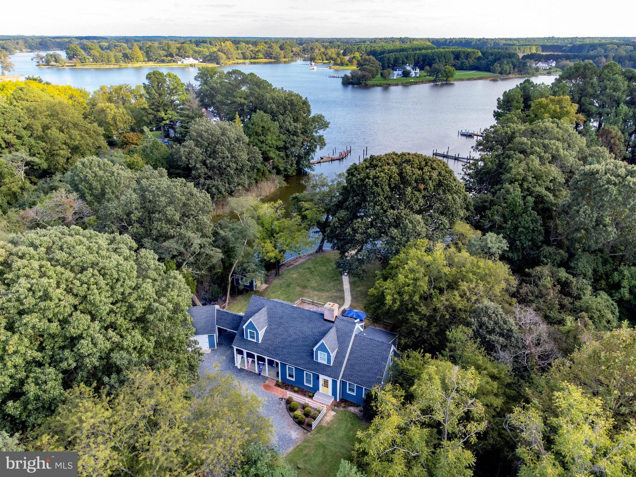 Simply Sublime - fabulous Oxford waterfront retreat on Island Creek! With southern exposure and long water views, this thoughtfully renovated house has water views from almost every room. Located in the highly desirable Oxford Road corridor, this home features an open floor plan that is ideal for entertaining year round. The great room with wood burning fireplace and custom built-in bar integrates perfectly into the dining room, showcasing the water and the grounds. The gathering spot for years to come is the newly renovated kitchen with butcher block counters, a generously sized island, stainless steel appliances, custom tile, LVT flooring and a nod to the nautical with cleat pulls on the custom cabinets.
First floor includes a comfortable primary bedroom suite with full bath and ample closet space, light filled separate formal living room with oversized wood burning fireplace, a laundry room and half bath. Second floor features a waterside oversized bedroom with vaulted ceilings, reading nook, a waterside third bedroom, a sitting room with additional closets, a waterside office/loft and full bath.
The property is situated on a private point with high elevation, sweeping yard, stately trees, fenced garden & patio, and waterside studio. The 150' long pier, composed of a 75' stationery pier and a 75' floating pier with plenty of room for sail and power boats has good water depth of 4’ MLW. A detached 13 x 22 garage/workshop that connects to the house with a breezeway rounds out this fabulous property!
Extensive recent renovations include new roof, siding, HVAC, flooring, interior painting, kitchen, crawl space, landscaping work, six new posts & re-decked pier, and except for the upstairs bathroom window, all the windows are new including the workshop/garage. Close to Oxford and Easton, this is an ideal waterfront retreat! Furnishings are negotiable.