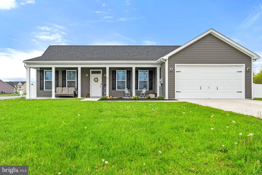 This pristine, three-bedroom, two bath rancher is a looker with its handsome neutral colors, lush lawns, and airy, light spaces. After an inviting front porch with room to relax beckons you inside, you’re welcomed by a high-ceilinged great room combining the common areas with custom blinds through-out the home. There’s ample room to create a comfortable haven for lounging and gathering. The corner kitchen has a bank of cabinets, granite countertops and a matching eat-in island with bonus bar stools, where you’ll enjoy more workspace and additional storage. French doors just past the dining area lead into a sunroom infused with windows, creating a perfect spot for reading or napping. Down the hallway, a generous owner’s suite comes with two walk-in closets and an attached bath containing a double-sink vanity, huge tub, and a deluxe separate shower. Two more comfortable bedrooms each with a walk-in closet, a second full bath, walk-in pantry, as well as a laundry area with the washer and dryer included, round out the home. Out back you’ll find a patio and a white vinyl fenced yard, giving you additional privacy, loads of recreation and gardening space, and the ability to contain your furry friends. Just over the Virginia border into West Virginia, this nearly new 1,644 sq ft home (built in 2020) sits on a huge, half-acre lot and has an attached two-car garage for added convenience.