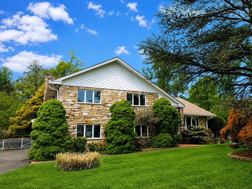 Welcome to this beautifully maintained stone and brick split-level home in the heart of Maple Glen, offering 3 bedrooms and 2.5 baths on a picturesque, fenced 0.61-acre lot with 5 access gates. Surrounded by mature specimen plantings including pine, holly, cherry blossom, maple, dogwood, and arborvitae. This park-like setting provides both privacy and charm, along with a large storage shed and plenty of space for outdoor enjoyment. This thoughtfully designed multi-level home seamlessly connects indoor and outdoor living while allowing natural light to flow throughout. Warm, earthy tones, exposed wood beams, and 2 striking stone Fireplaces create an inviting, relaxed atmosphere. The recently renovated main level features impressive 10.5-foot ceilings and an open layout ideal for modern living and entertaining. Notable upgrades include a newer Kitchen, Pella sliding glass doors, Andersen casement windows, bay window, Lennox Elite HVAC system, gas water heater, leaf guards with 6” gutters, central vacuum, ceiling fans, solid wood doors, and 2 floored Attics for exceptional storage. A covered Front Porch welcomes you into a bright Foyer with tile flooring and a spacious double coat closet. The gourmet Kitchen is beautifully appointed with custom soft-close maple cabinetry, granite countertops, under cabinet lighting, a breakfast bar, wet bar with wine storage, and KitchenAid stainless steel appliances including a 5 burner cooktop with downdraft and double wall ovens with convection. A pantry with pull out shelving adds convenience, while access to the partially covered upper brick Patio makes indoor-outdoor entertaining effortless. The open Dining and Living areas flow seamlessly, highlighted by a custom serving area and a stunning floor to ceiling stone gas Fireplace flanked by built-in maple cabinetry. Just a few steps down, the inviting Family Room features a second floor to ceiling stone Fireplace with a Hitzer cast iron insert, exposed beams, and Pella sliding doors leading to the lower brick Patio. This level also includes a well equipped Laundry/Mud Room with washer, dryer, utility sink, cabinetry, and exterior access, along with a spacious Half Bath and interior entry to the 2-car Garage with built-in storage. Upstairs, the Owners’s Suite offers a peaceful retreat with a walk-in closet and private Bath featuring tile flooring, a Corian-topped vanity, and a tub/shower. 2 additional Bedrooms share a Full Hall Bath with dual sinks and a tub/shower. The unfinished Basement provides excellent workspace with built-in cabinetry, shelving, and included workbenches, along with flexible space for hobbies, recreation, or additional storage. Enjoy outdoor living on 2 brick Patios overlooking a serene, private backyard perfect for relaxing, entertaining, or future enhancements such as a pool, play area, or garden. Located in the award winning Upper Dublin School District, this exceptional property combines timeless character, thoughtful updates, and an unbeatable setting. Located close to major roads including PA Turnpike, routes 63, 309, 152, 611 and close to Ft Washington and Ambler train stations, Mondauk, Aidenn Lair and Franklin Parks, schools, fitness centers, country clubs, houses of worship, and Maple Manor Swim Club. Convenient to the Promenade at Upper Dublin with shops and restaurants, downtown Ambler with cafes and theater. Located in a fabulous neighborhood with sidewalks and mature trees. This solid and warm home will bring you a lifetime of happiness! 1 year HSA warranty to the lucky buyers!