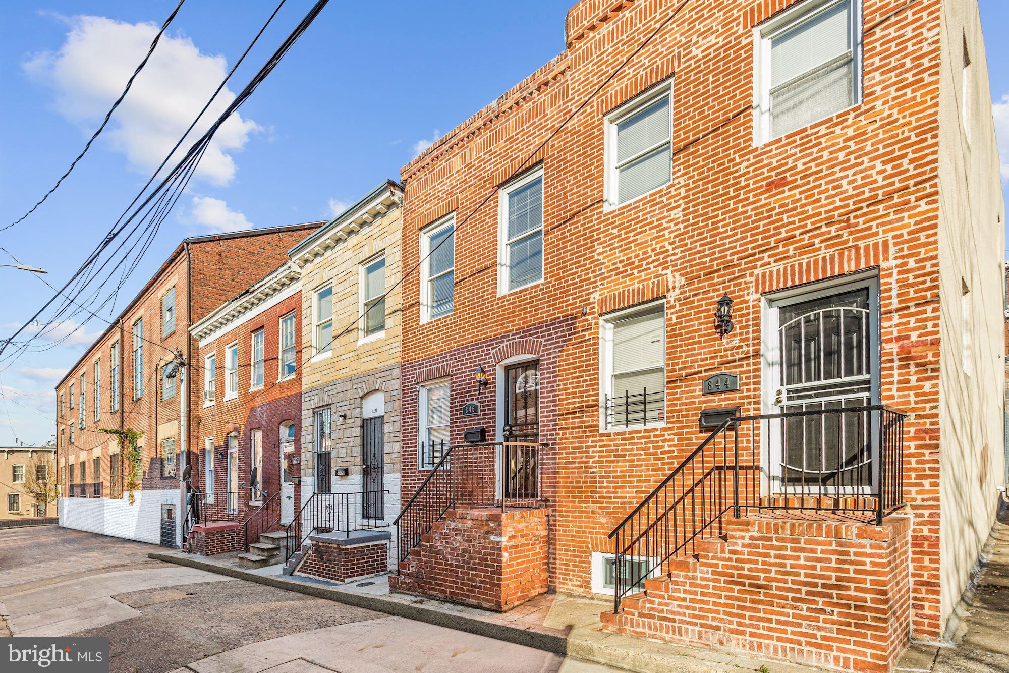 Beautifully renovated rowhome in close proximity to entertainment, shopping, and dining! Arrive into the main level living and dining room combination and experience an exposed brick accent wall, crown molding, chair railing, box wainscoting, and gorgeous hardwood floors. Let the kitchen inspire gourmet meals boasting 42" soft close cabinetry, stainless steel appliances, access to the fenced patio, and granite counters. The upper level provides two sizable bedrooms, one with access to a private balcony, as well as a hall bath featuring ceramic tile, jetted soaking tub, and walk-in shower. A fully finished lower level family room with a full bath provides an ideal space for movie night or home office. Major commuter routes include US-40, I-395, and I-95.