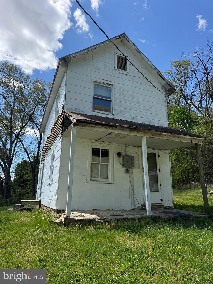 2‑story, 2‑bed farmhouse on 4  acres. Property includes detached 2‑car garage, existing well and interior shower (no full bathroom). No septic system on site. Excellent opportunity for renovation or redevelopment in a peaceful rural setting. Sold AS‑IS; buyer responsible for verification of utilities, permits and septic needs.