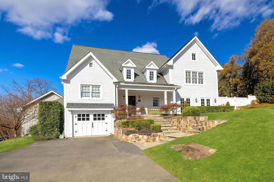 Originally built in 1940, this historic Piedmont farmhouse is a 5-bedroom, 4.5 bathroom McLean landmark property that has undergone multiple comprehensive renovations and additions, blending timeless architecture with modern sophistication and classic design. The downtown McLean property offers approximately 6,800 square feet of refined elegance on its combined 0.66 acre lot(s) on 2 parcels (tax map #0302 02A 0002 and #0302 02A 0002B), with a 3-car garage plus an additional 1-car garage/workshop.
 
Gorgeous hardscape and landscaping designed by Marion Oxford Dearth Landscape Design showcases the spacious, private flat rear yard and includes flagstone patios and walkways, stone walls, French pebble walkways, outdoor speakers, patio heaters, as well as a state of the art irrigation system with 20 zones. The rear and side yard is fully fenced with mature perimeter trees that provide excellent privacy.
 
Inside, discover custom window treatments, bespoke built-ins, pine heart floors, French doors with Cremone bolt hardware, abundant natural light and designer lighting throughout, even extending into the custom pantry. The kitchen is outfitted with custom cabinetry; Subzero, Wolf and Miele appliances; Perrin & Rowe plumbing fixtures; honed granite countertops and a large island. An unexpected moment in the home is the lovely butler’s pantry with bespoke cabinetry built by Micheal Bruner and adorned with Cole & Son wall coverings. The formal dining room and formal living room, with its rows of French doors with handsome updated fireplace hearth, are perfect for gatherings. The hearth room adjacent to the kitchen opens to the rear yard with additional French doors. The wine bar and breakfast nook together enhance both functionality and flow and lead to an incredible kitchen scullery with additional bespoke cabinetry. The family room features window seats by Michael Bruner, custom paneling, and molding and a multimedia system with surround sound as well as French doors to the rear yard. Adjacent to the family room is a gorgeous guest bedroom with en-suite bath allowing for the perfect setting for in-laws or longer term guests.
 
The upper level primary suite offers a large walk-in closet with custom Polyform European cabinets, a spa-like bathroom with dual vanities, a pedestal tub, Restoration Hardware fixtures and a stunning marble shower. Secondary bedrooms and baths have been updated with designer lighting and luxury finishes, complementing the home's cohesive style. 
 
The three-car attached garage is upgraded with Eggersmann Cabinetry, a Tesla Fast Charger, Storage Paneling and TV. The front 1-car garage features a finished sink area with ceramic floor tile and a custom Walpole barn door. The house features newer HVAC systems, meticulously maintained, replaced in 2020 and 2023. Solar  panels were added in 2018 with 2 Telsa Powerwalls which serve as a whole house generator during power outages and as an everyday energy saving tool.
 
Located in Downtown McLean, only two blocks from amenities such as the Dolley Madison Library and McLean Community Center, this home is minutes from Washington D.C., N Arlington, and Tysons Corner. Don’t miss this extraordinary opportunity to own an incredibly special home that blends luxury, comfort, and meticulous attention to detail.