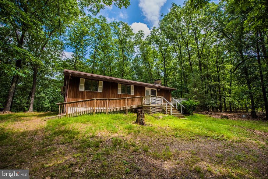Full time or just a weekend retreat!  3BR, 1BA rancher in a private wooded setting situated on 7.48 Acres.  Living Room, Kitchen and Dining are an open floor plan, with a front deck and covered back deck ready for screening to make it a screened in deck.  Usable land at the end of a cul-de-sac in a sub-division just minutes to the Virginia/West Virginia line for easy commuting.