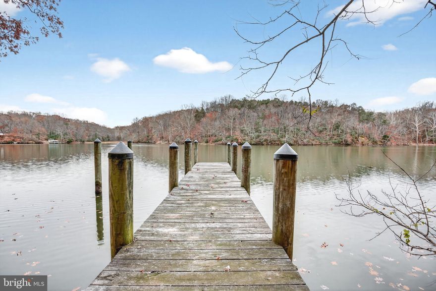 *Sale fell through as buyer got cold feet - their loss is your gain!*
Start your New Year with a showing of this waterfront home that is priced under $500,000! Discover the perfect blend of waterfront living and peaceful privacy in this 3-bedroom, 3-bath home with endless potential. Nestled on nearly an acre lot with mature trees, this property offers direct water access and a newer pier with pylons already in place—ready for you to add your ideal boat lift. A gently graded path wide enough for a golf cart or 4-wheeler makes getting to the water effortless.

Inside, you’ll find beautiful hardwood floors, spacious bedrooms, and a layout ready for your updates and personal touch. The primary bedroom and living room have beautiful high vaulted ceilings that give a luxury feel to this private wooded waterfront sanctuary.  The basement offers a beautiful wood burning stove that opens up to space for entertaining. Whether you’re looking to modernize or simply refresh, this home offers an incredible opportunity to create the waterfront retreat you’ve been dreaming of. 

Step outside to a large back deck perfect for morning coffee, evening sunsets, and hosting friends. With ample wooded privacy and room to relax, this outdoor living space is truly a highlight.

Bring your vision and unlock the full potential of this exceptional waterfront property—your dream home on the water awaits!