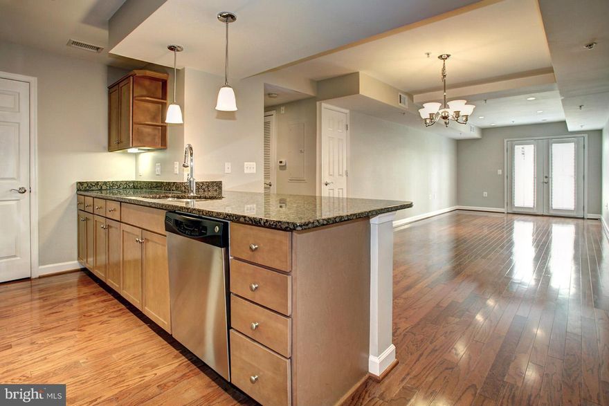 Come see this beautiful 1BR, 1BA condo in Shirlington! Ground level end unit w/ stone walked outdoor patio. Hardwood floors thruout, gourmet kitchen with granite, SS appl, breakfast bar w/ pendant lighting. Separate dining room and living room w/ French door access to the patio. Large BA w/ ceramic tile, pvt water closet. MBR w/ custom walk-in closet. Home Warranty.