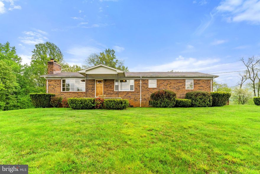 Picturesque country property , Original owner home.  Solid all brick rambler with stunning views of the Blue Ridge  Mountains and Shenandoah National Park & Skyline Drive.    2 finished levels with 4 bedrooms, 3 full bathrooms, Spacious kitchen & breakfast area with a picture window to admire the views, Family room with original hardwood floors, wood burning fireplace and a wall of windows to take advantage of the views!  3 Bedrooms on Main level including owner's suite all with hardwood flooring, Mostly finished basement with woodstove, 4rd bedroom, 3rd full bathroom , laundry room, storage and more.  Lovingly maintained and very neat and clean!  Mostly open 2.65 acres with NO HOA,  great cell phone service as well as internet!  Enjoy all that Flint Hill and Rappahannock County has to offer with plenty of restaurants, shopping, and wineries nearby.    Perfect full time or weekend residence!