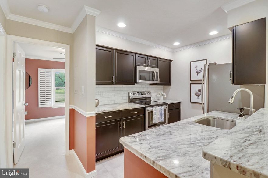 Gorgeous updated unit at the Ponds at Centreville/Clifton with wonderful community amenities. Lovely ground floor unit has a gorgeous renovated kitchen with newer cabinets, stainless steel appliances, granite countertops & classic subway tile backsplash.  Updated marble-tiled bathroom has modern frameless shower door.   Fantastic views- pond view right out of the bedroom window.  Assigned parking spot is directly in front of door.  In-unit laundry and loads of amenities such as clubhouse w exercise room, community pool, tennis court, tot lot, jogging paths & more!  The Ponds of Clifton/Centreville is a peaceful  condo community surrounded by trees, walking trails, and ponds.  Great location with commuter access to Rt 28, 29, 66, and Fairfax County Parkway.  Union Mill Elementary and Centreville High School pyramid. Move-in ready!