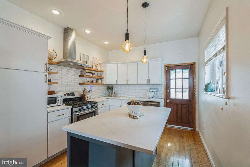 Beautifully maintained and improved 3 bedroom 1.5 Bath townhome in the awesome Pennsport neighborhood in Philadelphia. Entering through a double door foyer, you are greeted by a beautiful living room complete with a large bay window streaming natural light and natural hardwood flooring. With the open, straight through floor plan the cozy dining room shares space with a stunningly large kitchen featuring white wood cabinetry w/brushed gold hardware, natural wood shelves, large island, Quartz countertops, brushed gold goose neck faucet, upgraded SS appliances, incl. refrigerator, and chimney hood over the gas range/oven. The access to the rear yard is off the kitchen, The 2nd floor offers 3 spacious bedrooms with ample closet space & a lovely 3 pc bath. The basement is full size with a laundry area, including Speed Queen washer and dryer, newer mechanicals. Basement walls refinished in the last 3 years.  See Seller Disclosure for update details.  Close to all major highways, shopping and transportation this lovely home is conveniently located. Schedule your tour today!