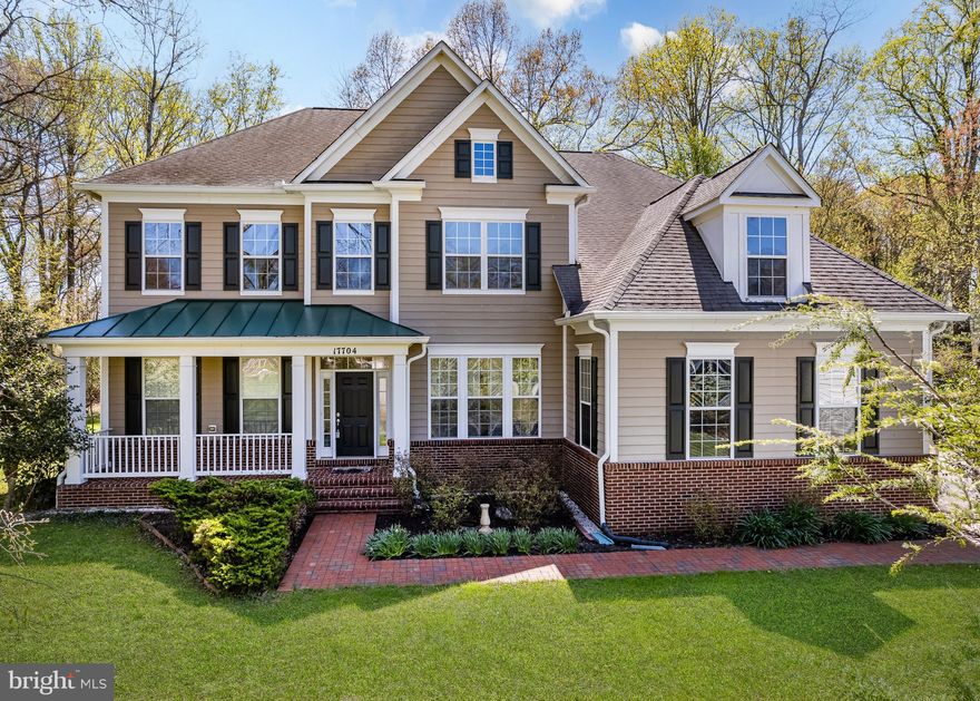 Experience a refined blend of elegance, privacy, and natural beauty. Set at the end of a quiet, secluded drive with no HOA dues or restrictions, this custom Ashton residence offers 5 bedrooms, 3.5 baths, a 2‑car garage, and more than 4,600 sq. ft. of thoughtfully crafted living space surrounded by mature trees. With Northwest Branch Stream Valley Park, The Adventure Park at Sandy Spring, and two premier golf courses just minutes away, the location delivers both tranquility and everyday convenience. The main level is designed for effortless flow and connection. Expansive sightlines link the family room, gourmet kitchen, bright breakfast area, formal dining room, and living room, creating an open, welcoming environment. Ten‑foot ceilings on all three levels elevate the sense of space, while the family room stands out with its column details, crown molding, chair rail accents, and a dramatic floor‑to‑ceiling stone gas fireplace. Rich hardwood floors run throughout the main level. The gourmet kitchen features 42" cherry cabinetry, stainless steel appliances, and Corian countertops, opening a sunlit breakfast room and a spacious deck overlooking a private, flat backyard. Upstairs, five generously sized bedrooms each include a walk‑in closet, complemented by three beautifully updated baths. The owner’s suite offers tray ceilings and a spa‑inspired bath with a garden tub, separate shower, and jacuzzi. The full unfinished basement provides exceptional potential for a custom lower level—ideal for a home theater, gym, guest suite, or entertainment space. 
A rare offering in Ashton, combining space, privacy, craftsmanship, and an exceptional setting. Digitally staged images include furniture and window treatments for illustration.