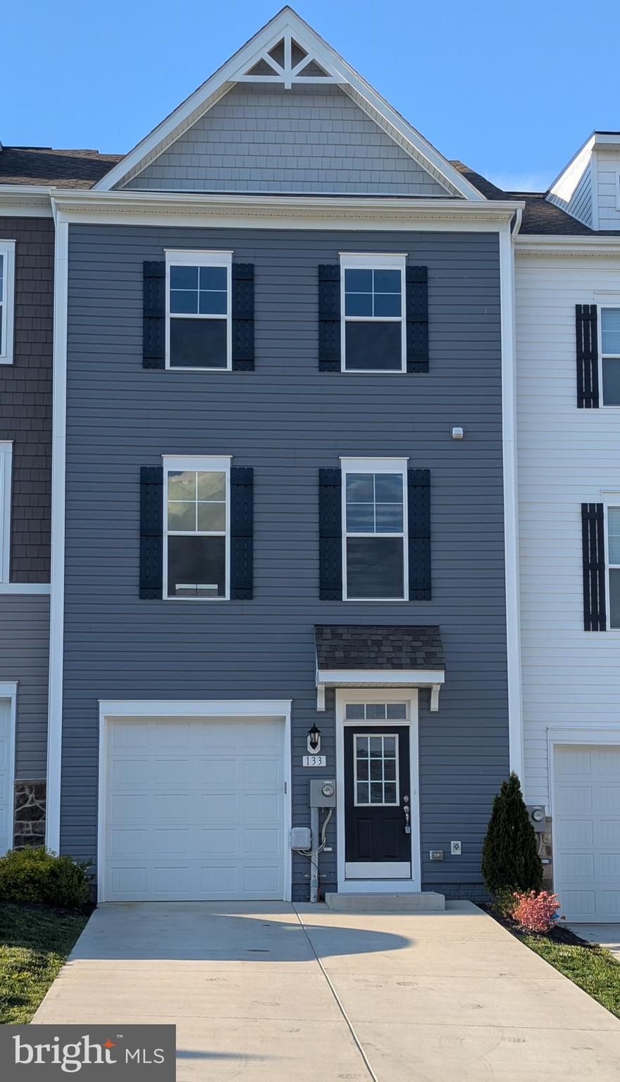 Welcome to this spacious 3-story townhouse in the sought-after Overlook community, featuring a long private driveway that easily accommodates up to four vehicles. The main level boasts a beautifully appointed kitchen with stainless steel appliances, a generous center island, and a cozy breakfast nook—perfect for casual dining. Just off the kitchen, the expansive living room provides plenty of space for entertaining and includes a convenient half bathroom.

Upstairs, the primary suite offers a touch of luxury with a tray ceiling and a large walk-in closet. The upper level also includes two additional bedrooms, a full bathroom, and a dedicated laundry room with a washer and dryer hookup for added convenience.

The entry level features a one-car garage, a large coat closet, and a versatile rec room that can serve as an office or fourth bedroom, complete with its own full bathroom—ideal for guests or extended family.