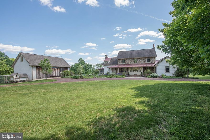 Authentic Reproduction of 18th Century Farmhouse situated on a private oasis of 7 plush acres of gorgeously manicured grounds in Historic Birchrunville.  The architectural detailing is spot on, includes antique hardware, reclaimed wide plank hardwood flooring, old chestnut beams seamlessly blended inside yet an open floor plan  with the feel of yesteryear but the amenities of the 20th Century.  Beginning with the country charm of period stonework step up to covered front porch(8' x 46') with beautiful new flooring and raised seam metal roof .  The custom millwork throughout is representative of work from an earlier period.  There are 2 "Count Rumford" designed wood-burning fireplaces that boast legendary thermodynamics attractive for energy efficiency and with the traditionally tall blueprint it blends well with the tall 9' ceilings on first floor.  "Waterbury" designed open kitchen with huge cutting block top center island(5' x 7'), SubZero fridge, Thermador and Bosch appliances, soapstone counters and 9" deep sink which easily allows serving the adjoining breakfast area.   The Chef can cook while conversing into the dramatic, wide open, cathedral ceiling Family Room with 20'6" center peak, classic Stone fireplace(6' x 7') with antique chestnut mante.  There's access to  high ceiling screened side porch(12' x 19') and south facing covered open porch(7' x 19') in rear with brick floors and wide brick stairs down to bluestone patio(17' x 20').  Off the Dining room is another covered open porch(5' x 14') and walk out to new sunken 8' diameter Firepit for nightime gatherings.  Original design has the 2nd floor master suite and adjacent reading area/office(9' x 19') with balcony overlook to Family room.  Later the 1st floor Master suite was added with sitting room entry into bedroom with cathedral ceiling, hand-hewn beams and efficient gas fireplace.  Large Master bath has dramatic cathedral ceiling with clerestory windows, custom marble & limestone, electric radiant heat floor, walk-in closet and through to yet another screen/glass porch(7' x 15') also accessed from Living room.  The free-standing bank barn boasts an oversized 3 car garage below and heated workshopabove has 900 sf(27' x 33') which could easily be converted to studio or living space, the perfect he/she cave!  Both house and barn have lightning protection systems and the grounds are complimented with extensive colorful gardens.  Close to Birchrunville, a sense of place still strong in this crossroads village that has a past that extends behind and ahead.  Seasoned visitors call this hamlet the "Switzerland of America", the contours of the land with rugged hills, deep valleys, pristine streams taking you back into history,...a very cool place to live!!!