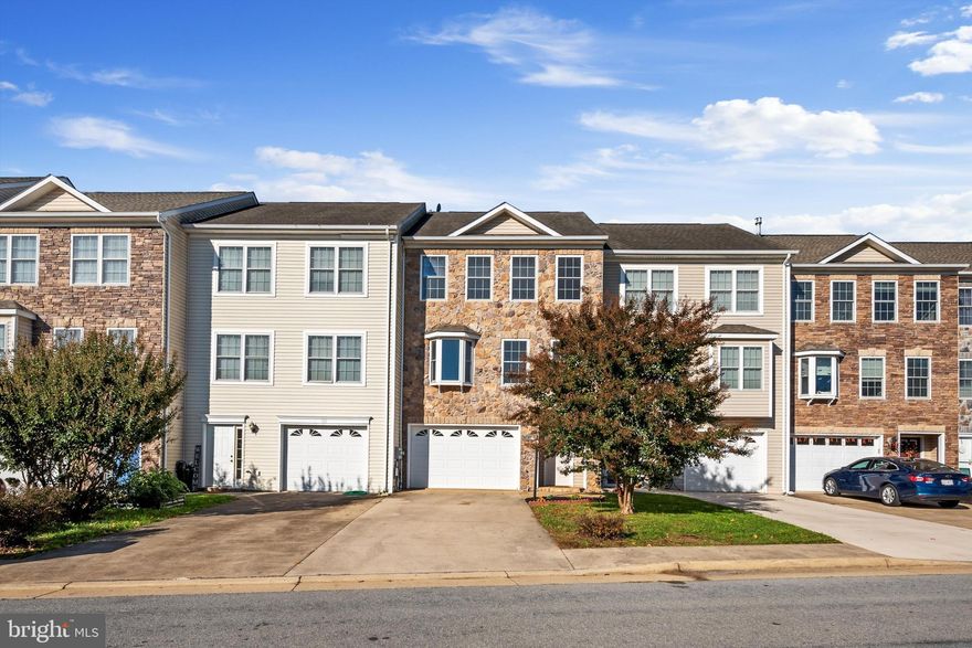 Gorgeous stone front townhome located in the sought-after Locust Hill Golf Course community with views of the golf course. This home has 3000+ square feet of finished living space! All 3 levels are finished, freshened up and ready for you to move right in! Walk in at the foyer and head back to the half bath, laundry room, and HUGE finished recreation room on this lower walk-out level. The back yard space has a golf course view, patio, and fenced in area with gate. The main living level offers a family room with a bay window bump out, half bath for convenience, an eat-in kitchen with breakfast bar and stainless-steel appliances, and another large bonus room off the other side of the kitchen that could be used as a formal dining room, home office, or an additional living room... so many possibilities! On the upper level you find a large primary bedroom with attached ensuite that offers a jetted tub and separate shower, two more nicely sized bedrooms that share a full hall bathroom with a tub/shower combo. Attached 1-car garage with auto-opener and concrete driveway with two more private spaces. There is also an overflow parking lot for your guests. Come see it while it lasts!
